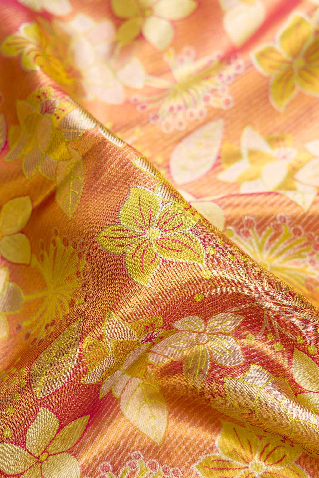 Close up of Gold Dual Tone Kanjivaram Tissue Silk Saree with Zari Brocade on the body and Zari Border.  displaying folds