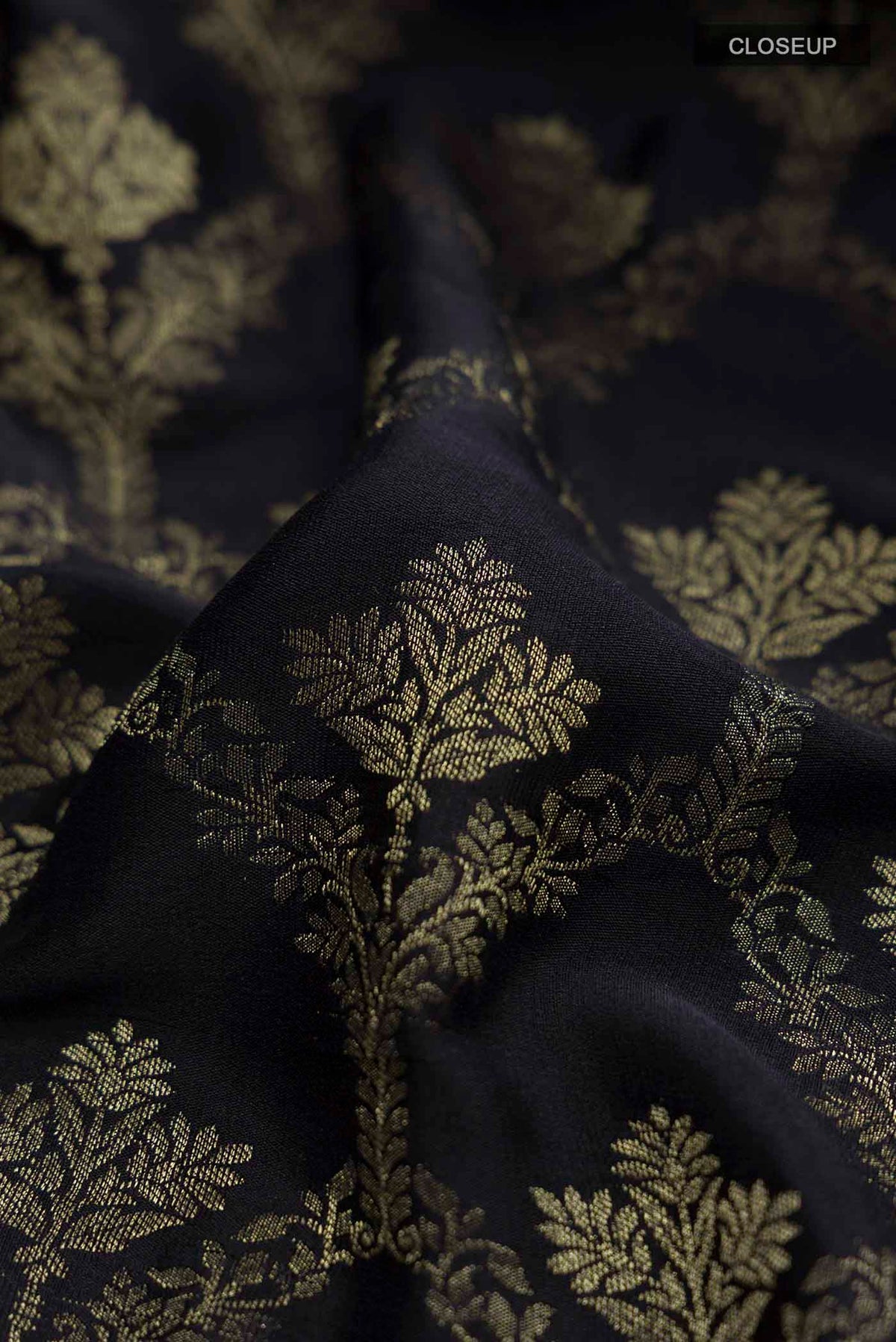Close up of Black Mysore Crepe Saree with Zari Butta on the body and Zari Border displaying folds