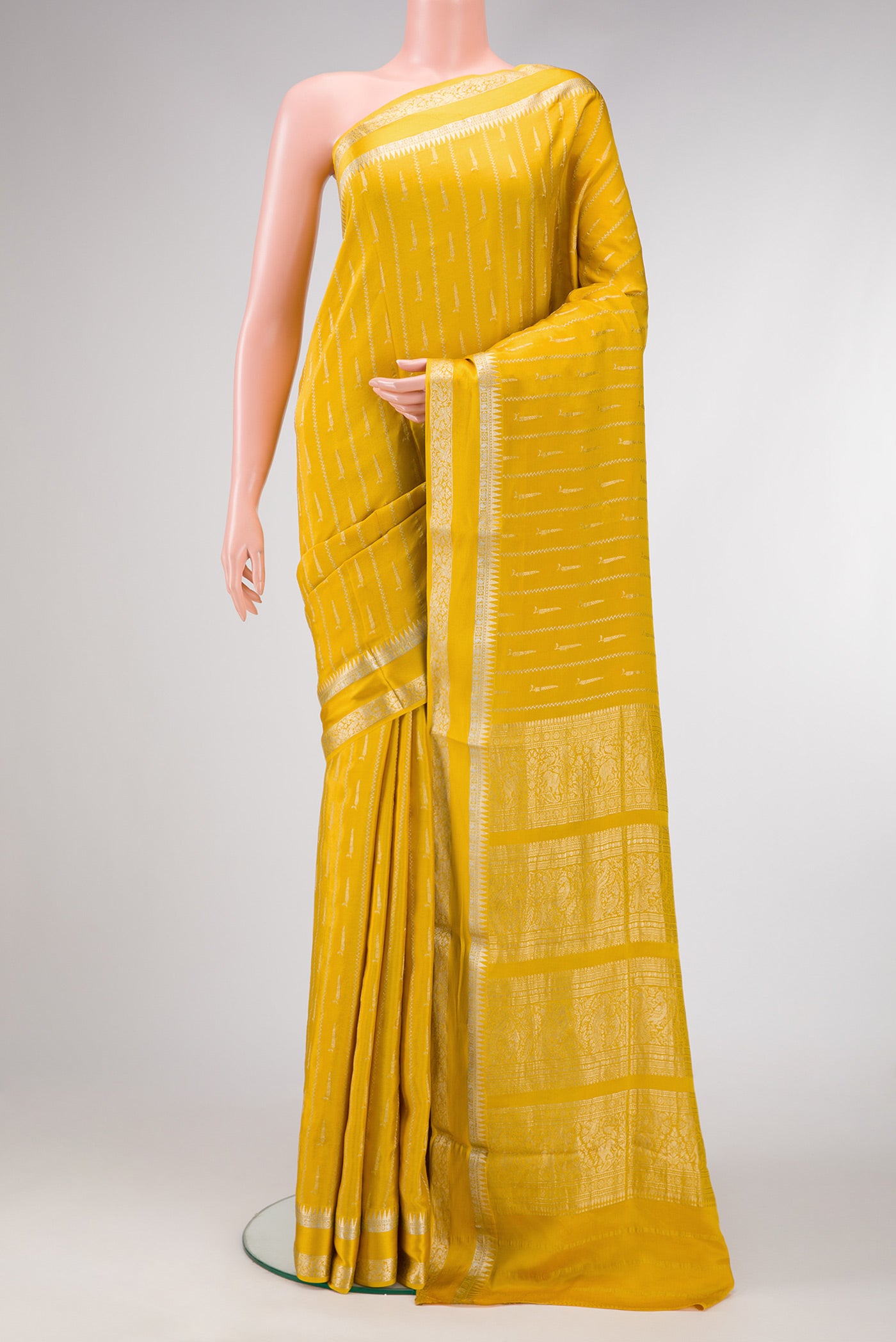 Mustard Dual Tone Mysore Georgette Saree with Stripes on the body and Zari And Thread Border.  displayed on a mannequin