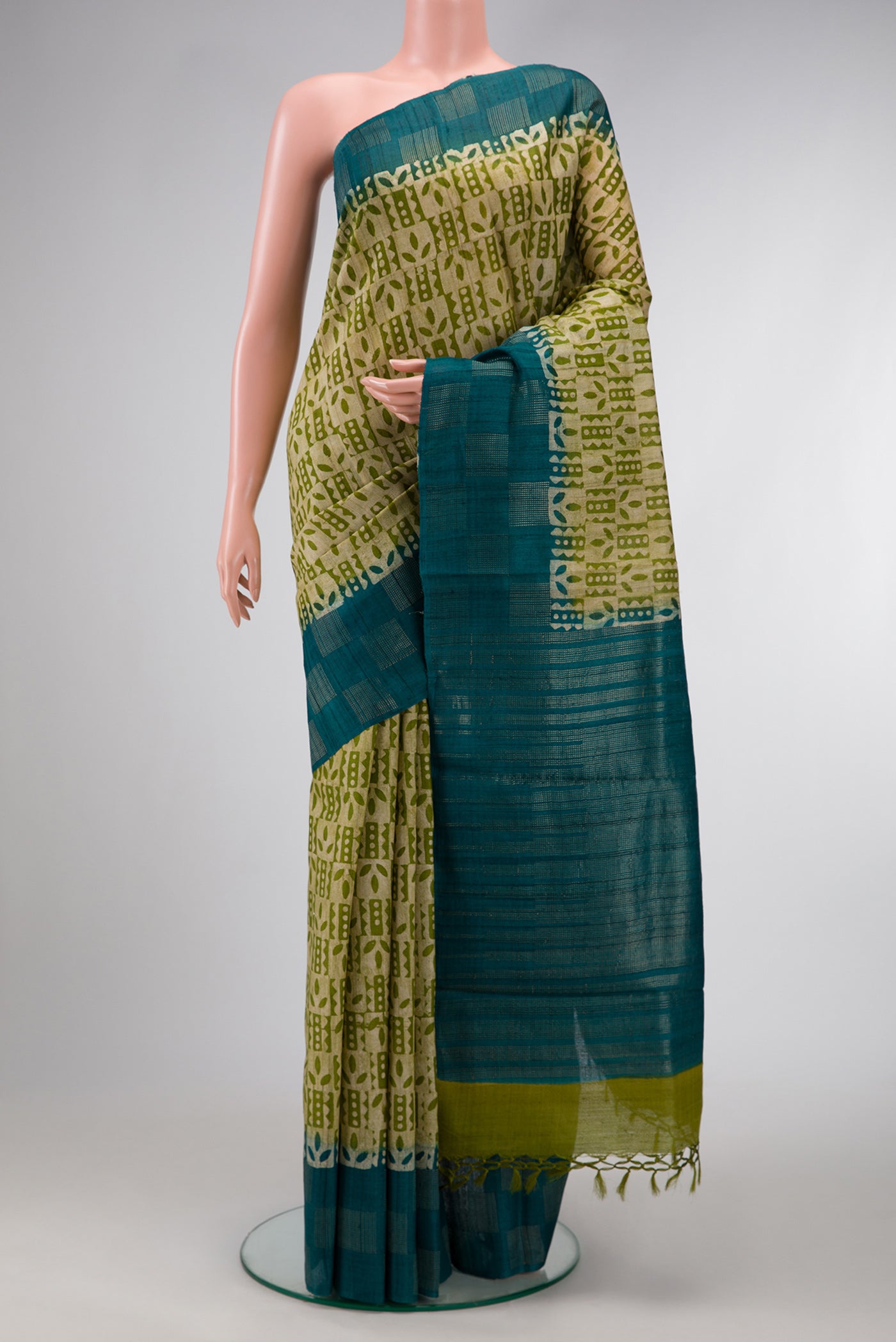 Mehandi Green Dual Tone Tussar Silk Saree with Printed design on the body and Fancy Border.  displayed on a mannequin