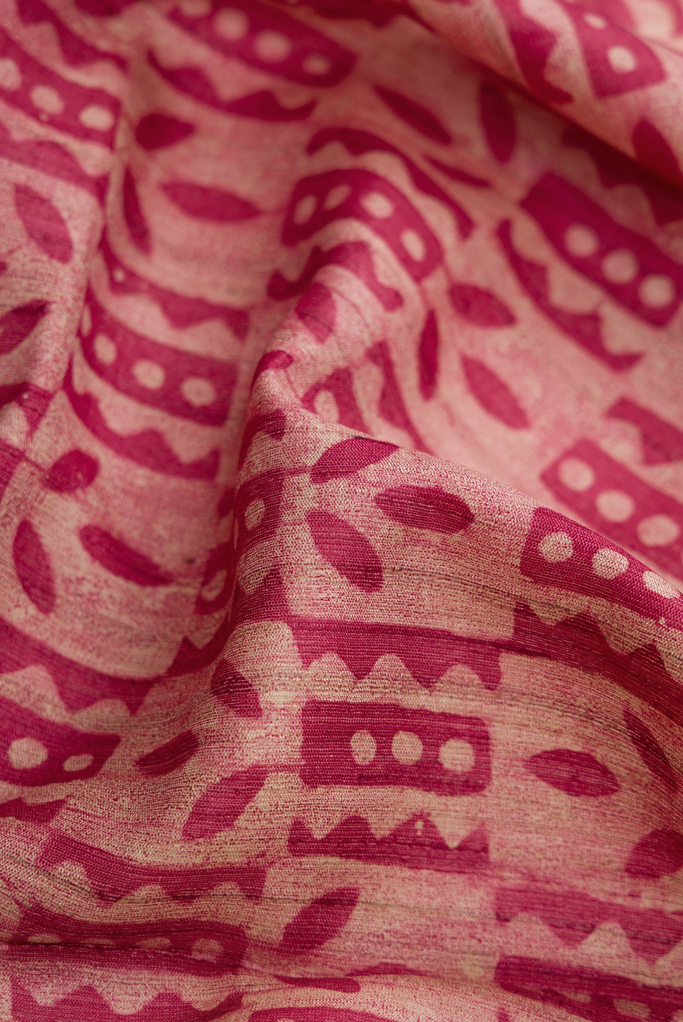 Close up of Beige Dual Tone Tussar Silk Saree with Printed design on the body and Zari Border.  displaying folds
