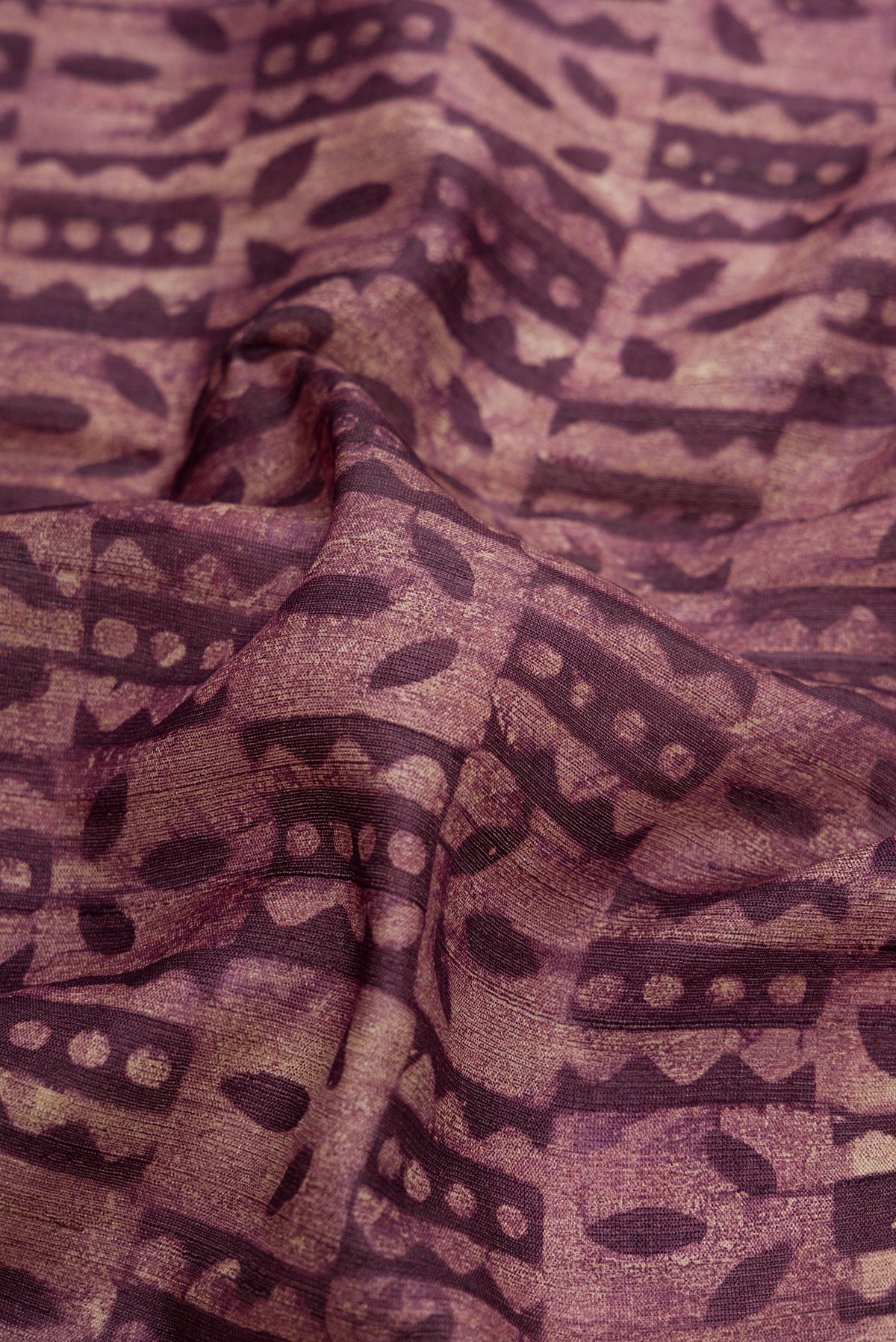 Close up of Purple Dual Tone Tussar Silk Saree with Printed design on the body and Zari Border.  displaying folds
