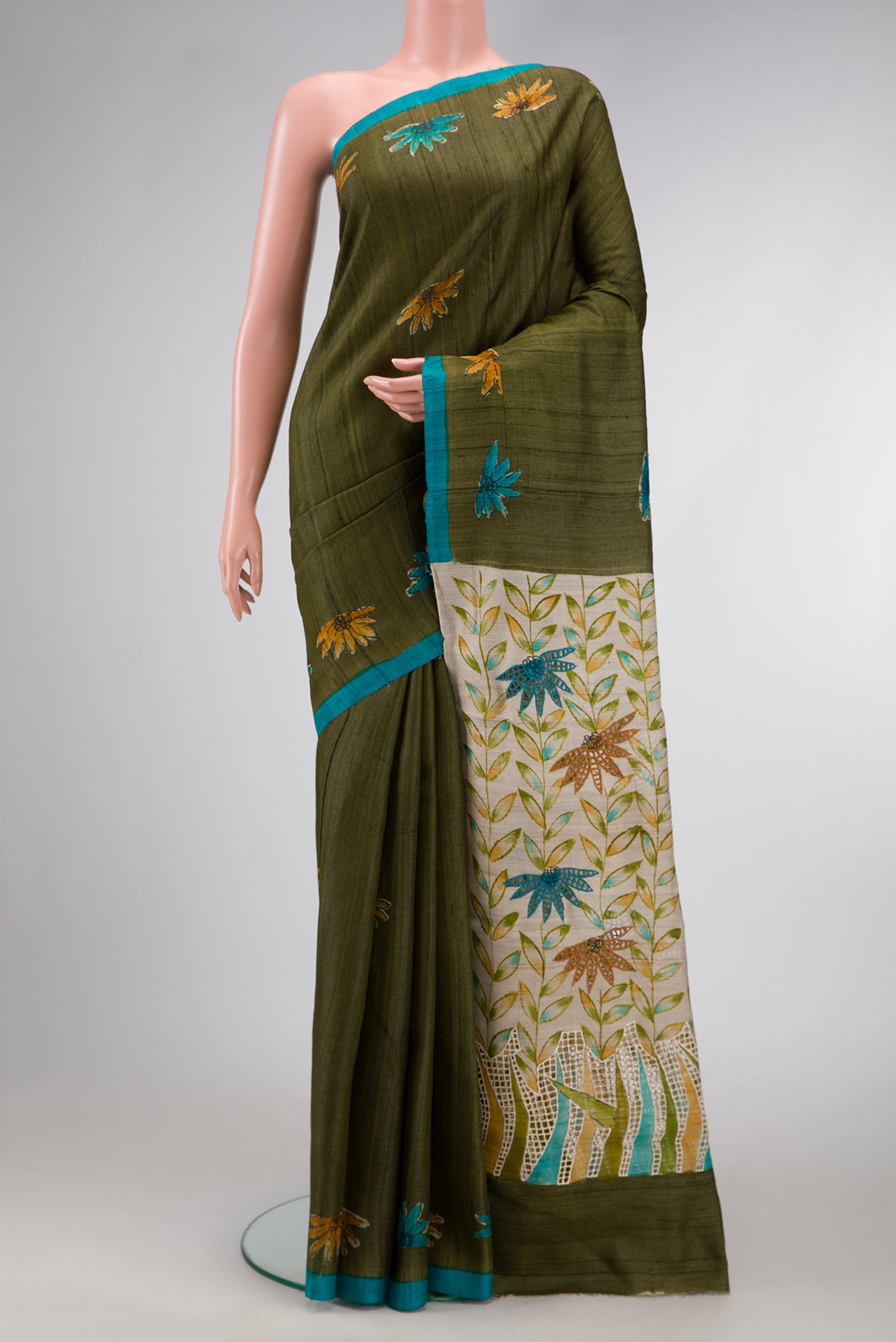 Green Dual Tone Tussar Silk Saree with Printed design on the body and Plain Border.  displayed on a mannequin