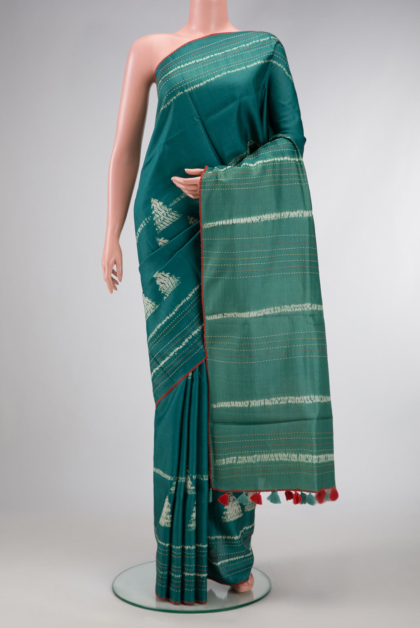 Green Dual Tone Tussar Silk Saree with Printed design on the body and Embroidery Border.  displayed on a mannequin