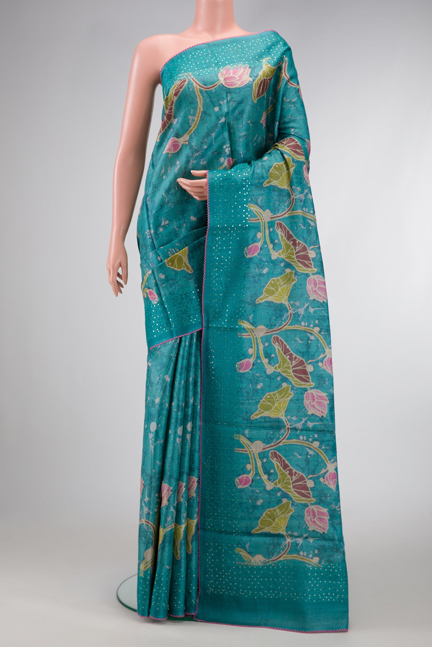 Maya Blue Dual Tone Tussar Silk Saree with Printed design on the body and Embroidery Border.  displayed on a mannequin