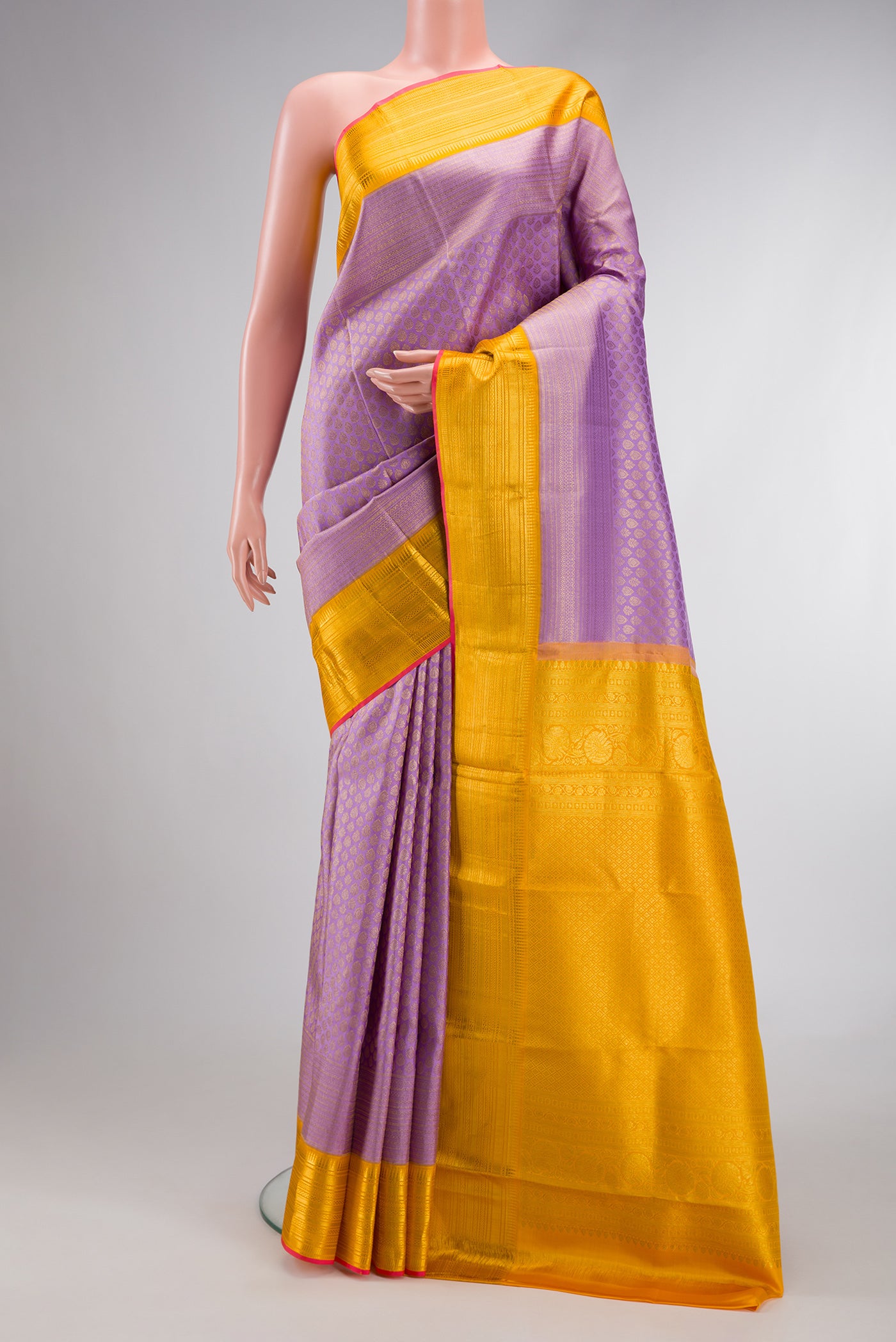 Lavender Dual Tone Kanchipuram Silk Saree with Zari Brocade on the body and Zari Border.  displayed on a mannequin
