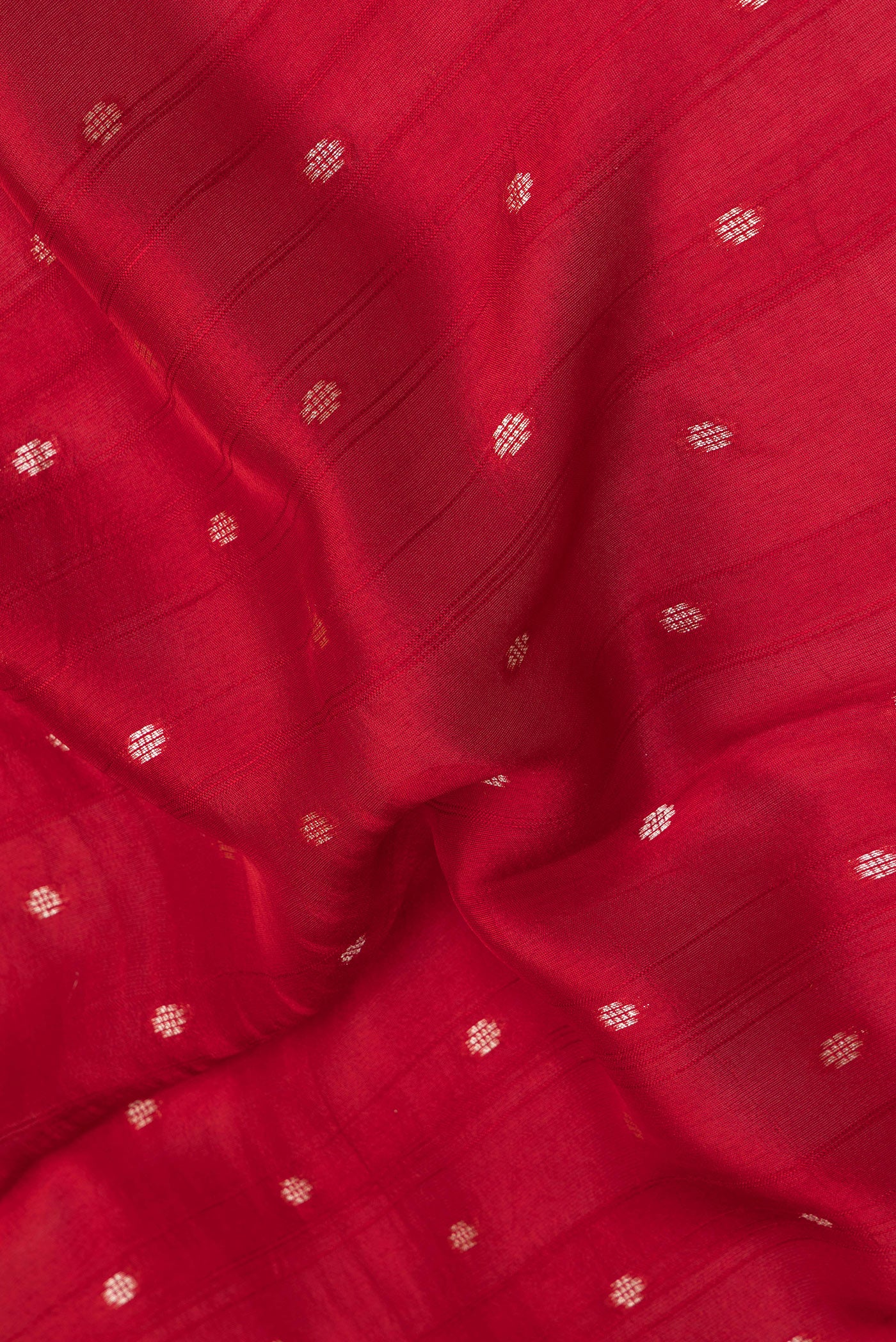 Close up of Red Blended Banarasi Silk Saree with Zari Butta on the body and Fancy Border.  displaying folds