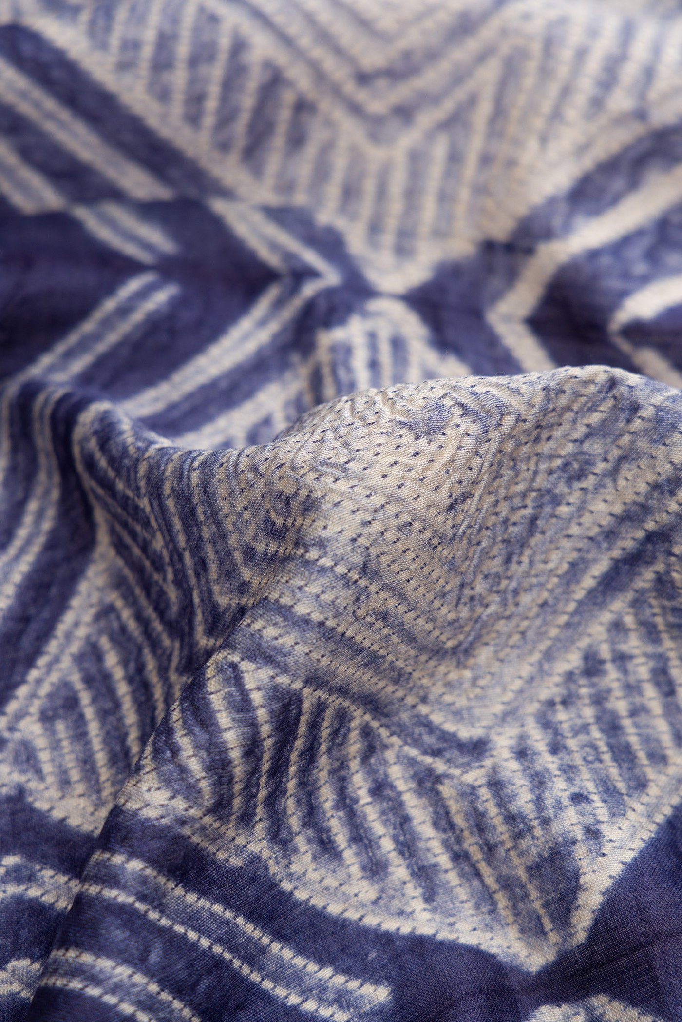 Close up of Navy Blue Dual Tone Tussar Silk Saree with Printed design on the body and Printed Border.  displaying folds