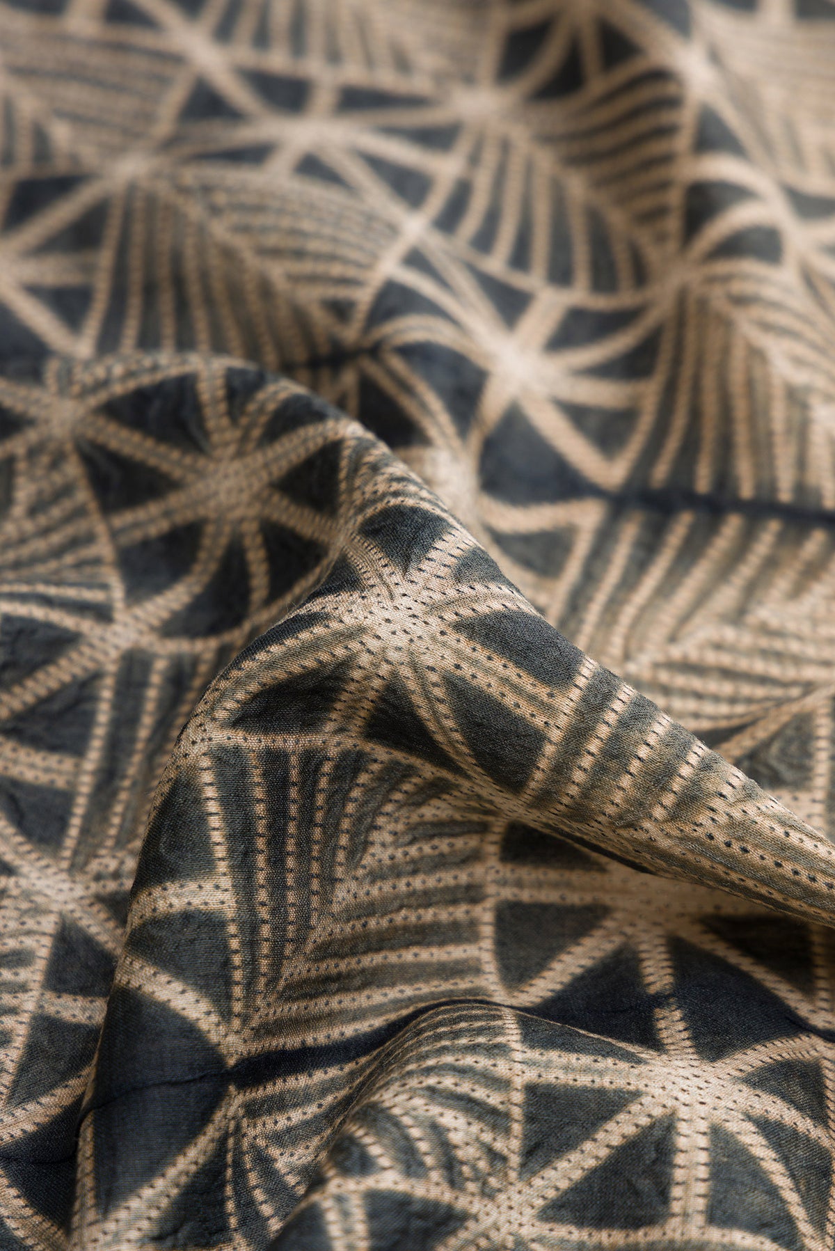 Close up of Navy Blue Dual Tone Tussar Silk Saree with Printed design on the body and Printed Border.  displaying folds