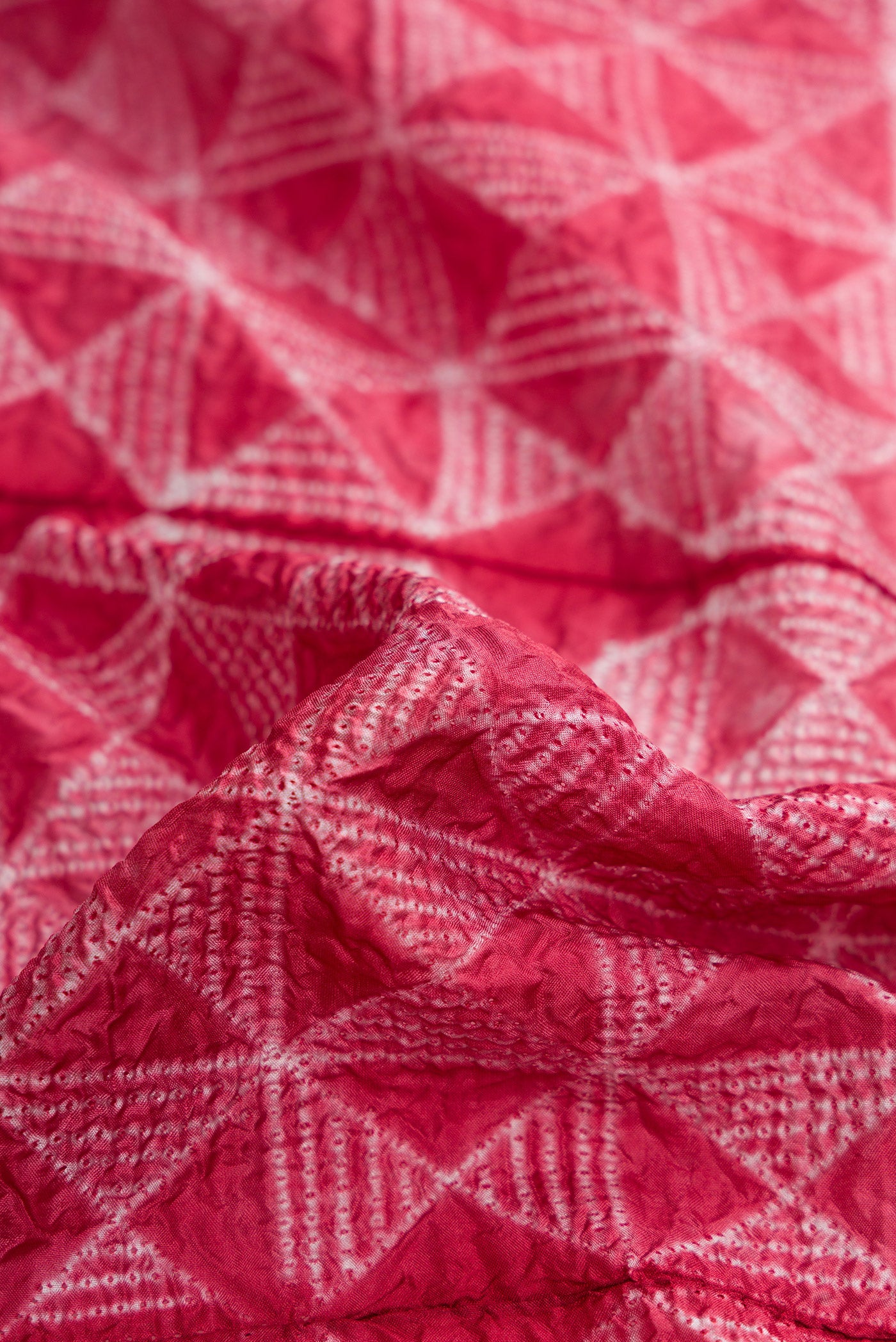Close up of Maroon Dual Tone Tussar Silk Saree with Printed design on the body and Printed Border.  displaying folds