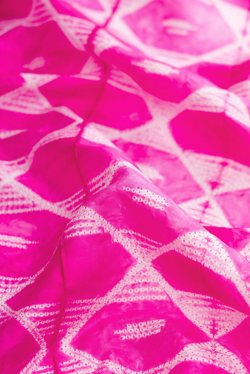 Close up of Pink Dual Tone Tussar Silk Saree with Printed design on the body and Plain Border.  displaying folds