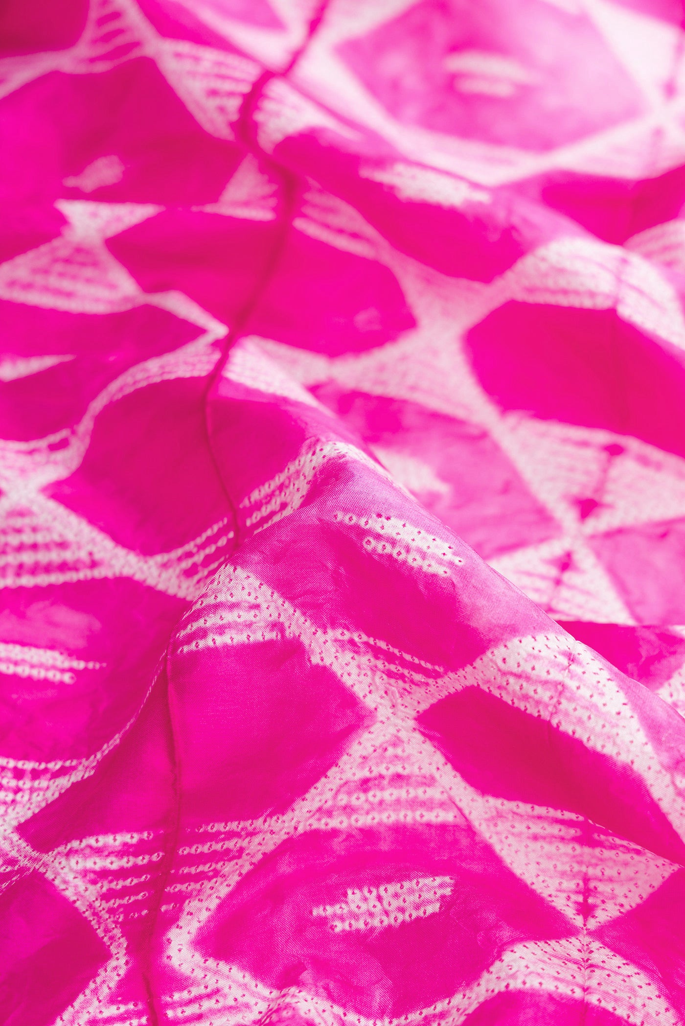Close up of Pink Dual Tone Tussar Silk Saree with Printed design on the body and Plain Border.  displaying folds