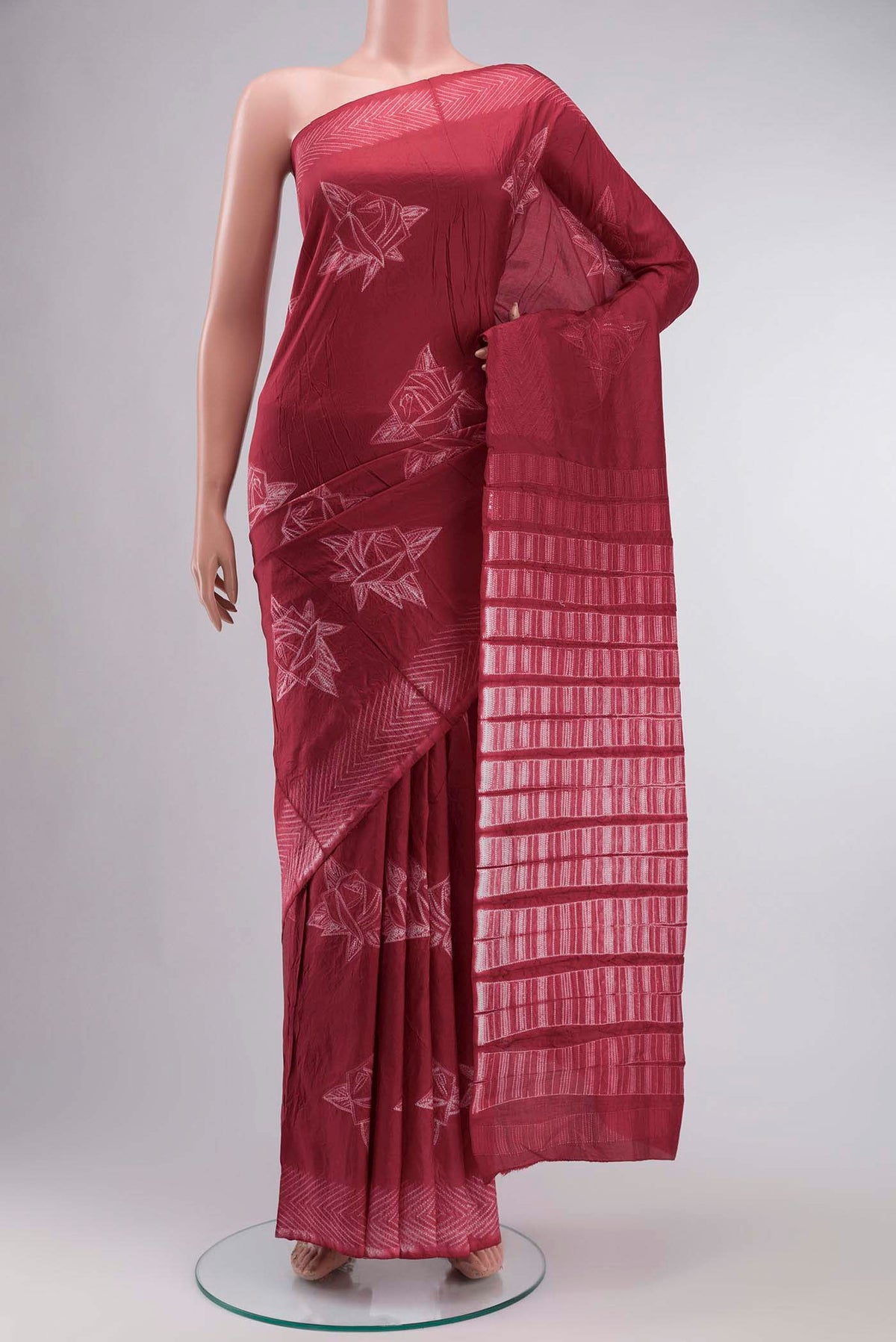 Red Tussar Silk Saree Printed design on the body and Without Border displayed on a mannequin