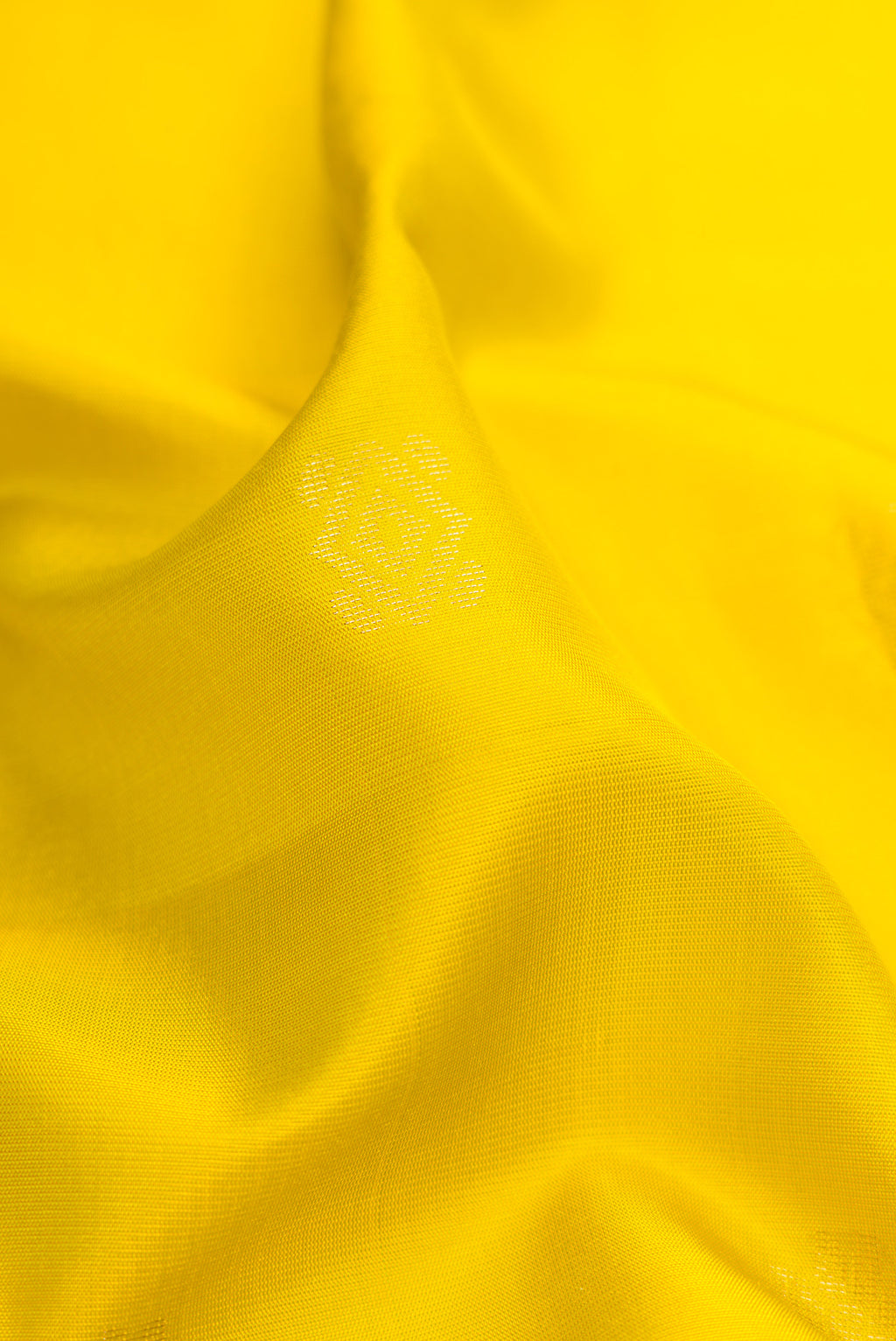 Close up of Parrot Green Dual Tone Soft Silk Saree with Zari Butta on the body and Zari Border.  displaying folds