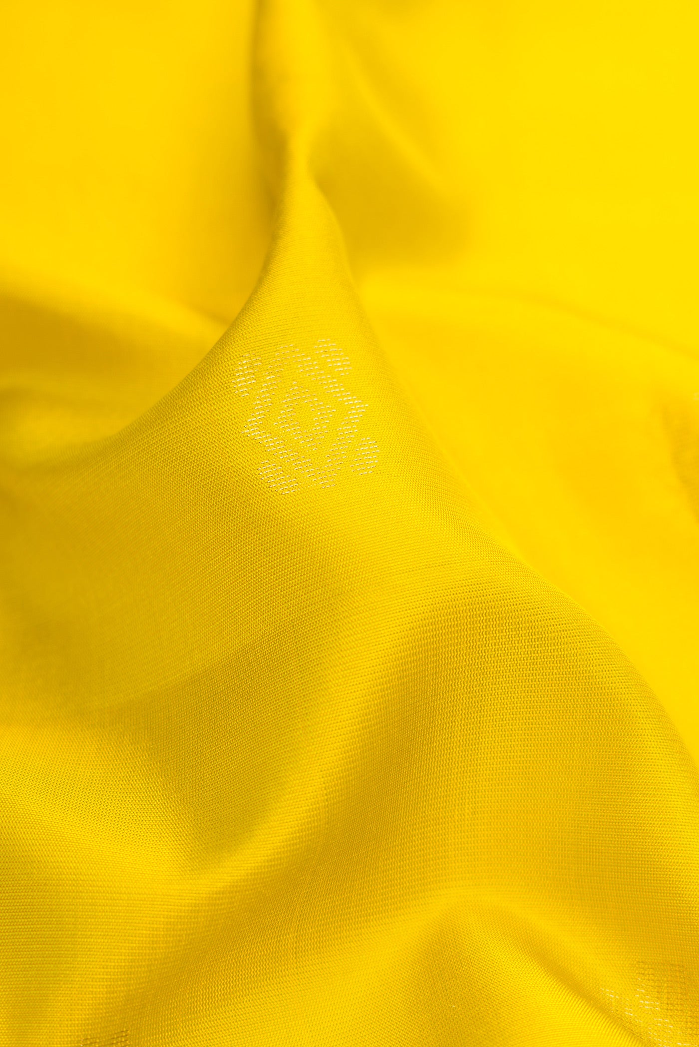 Close up of Parrot Green Dual Tone Soft Silk Saree with Zari Butta on the body and Zari Border.  displaying folds