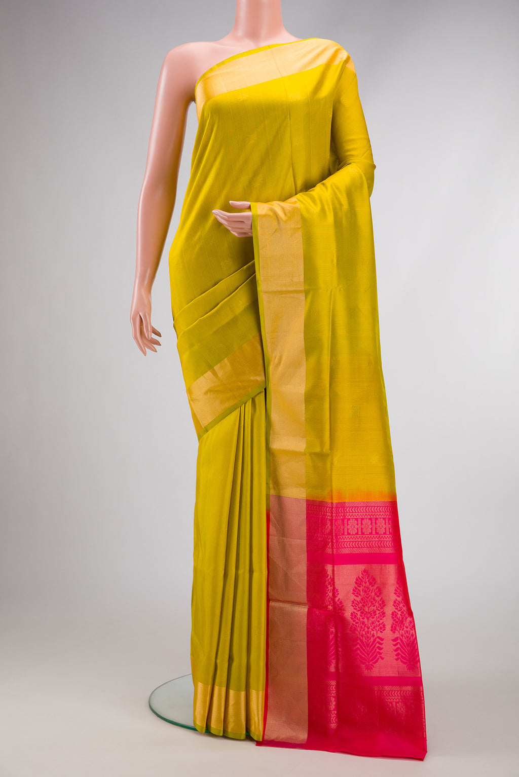 Parrot Green Dual Tone Soft Silk Saree with Zari Butta on the body and Zari Border.  displayed on a mannequin