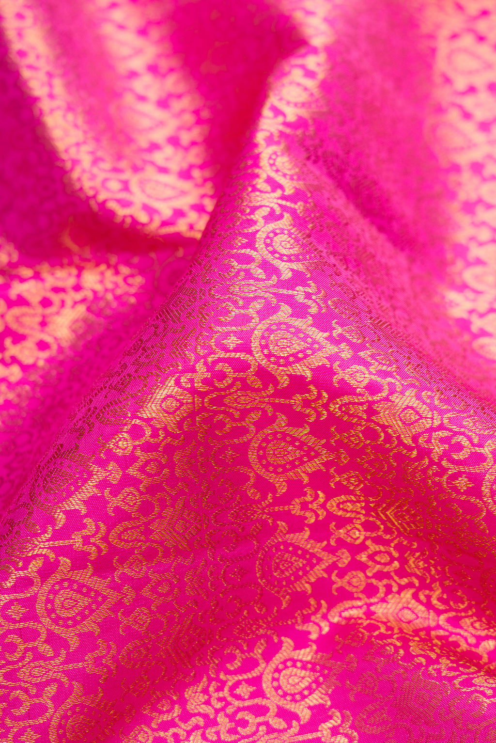 Close up of Pink Dual Tone Kanchipuram Silk Saree with Zari Brocade on the body and Zari Border.  displaying folds