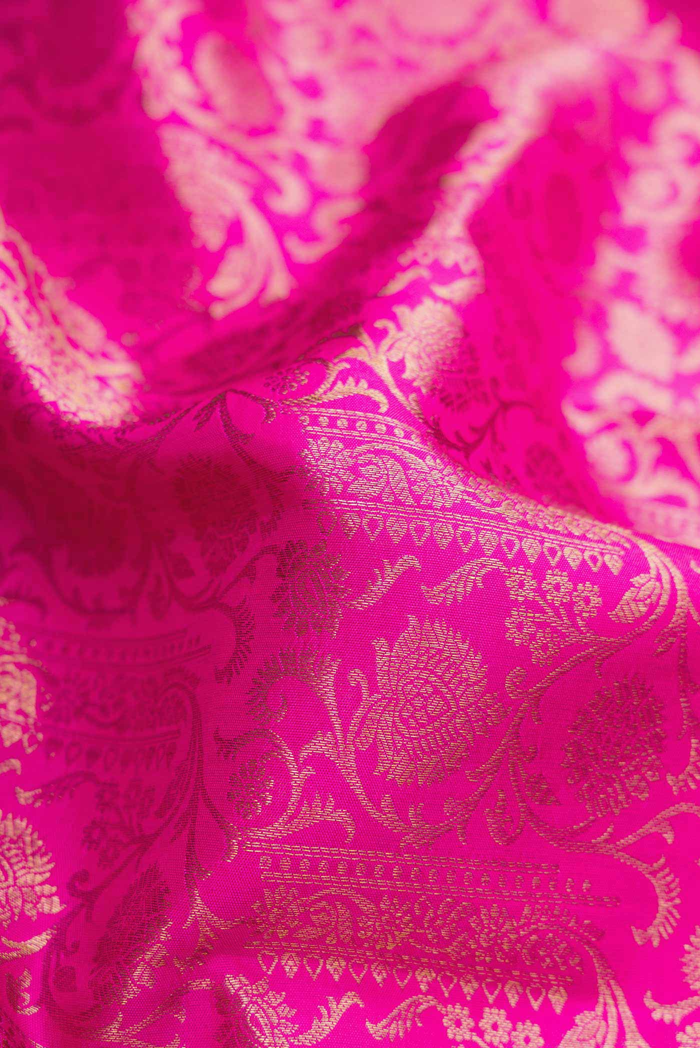 Close up of Pink Dual Tone Kanchipuram Silk Saree with Zari Brocade on the body and Zari Border.  displaying folds