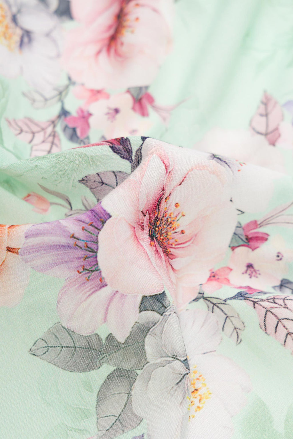 Close up of Sea Green Dual Tone Linen Saree with Printed design on the body and Zari Border.  displaying folds