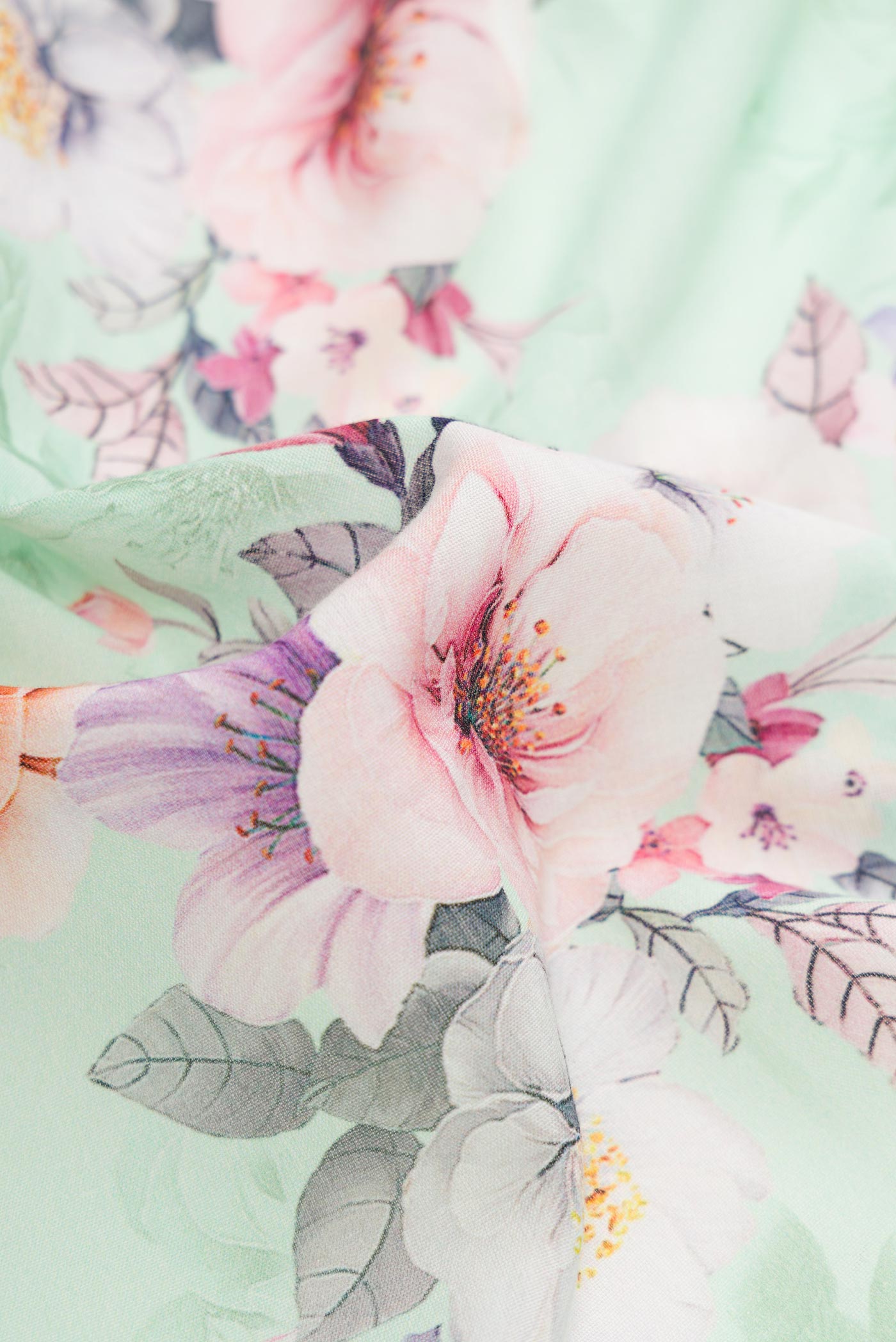 Close up of Sea Green Dual Tone Linen Saree with Printed design on the body and Zari Border.  displaying folds