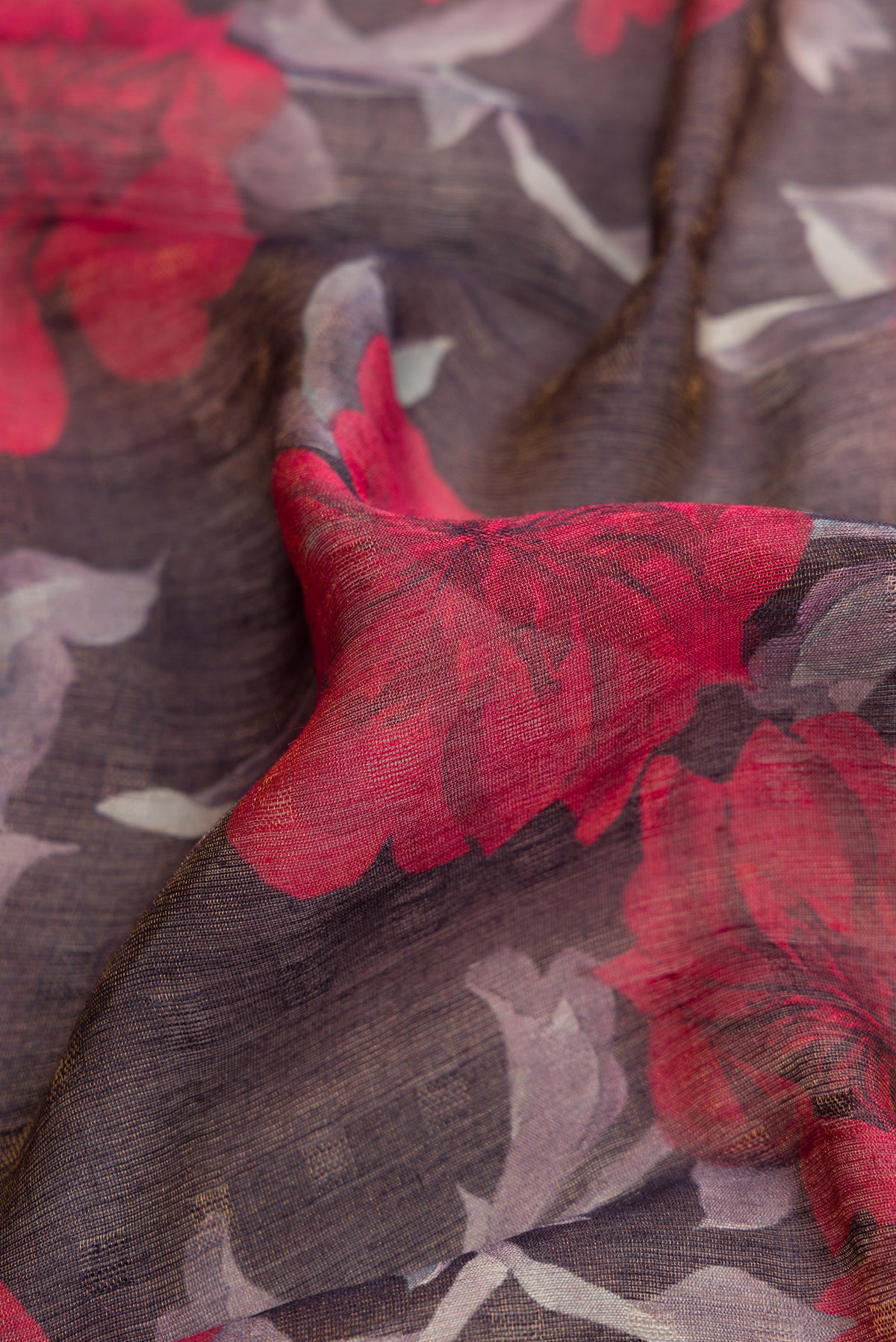 Close up of Brown Dual Tone Tussar Silk Saree with Printed design on the body and Embroidery Border.  displaying folds