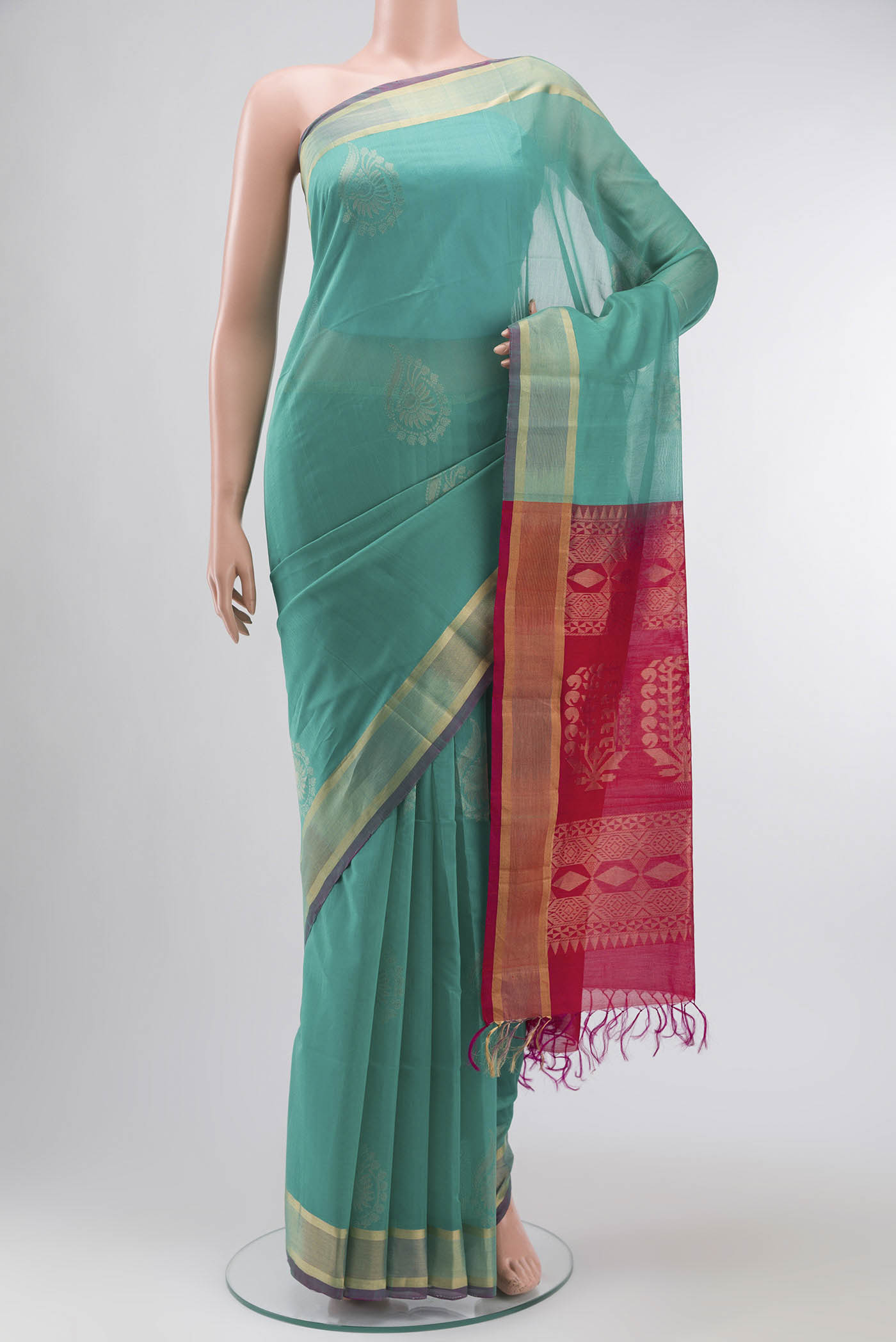 Sea Green Silk Cotton Saree with Zari Butta on the body and Zari Border displayed on a mannequin
