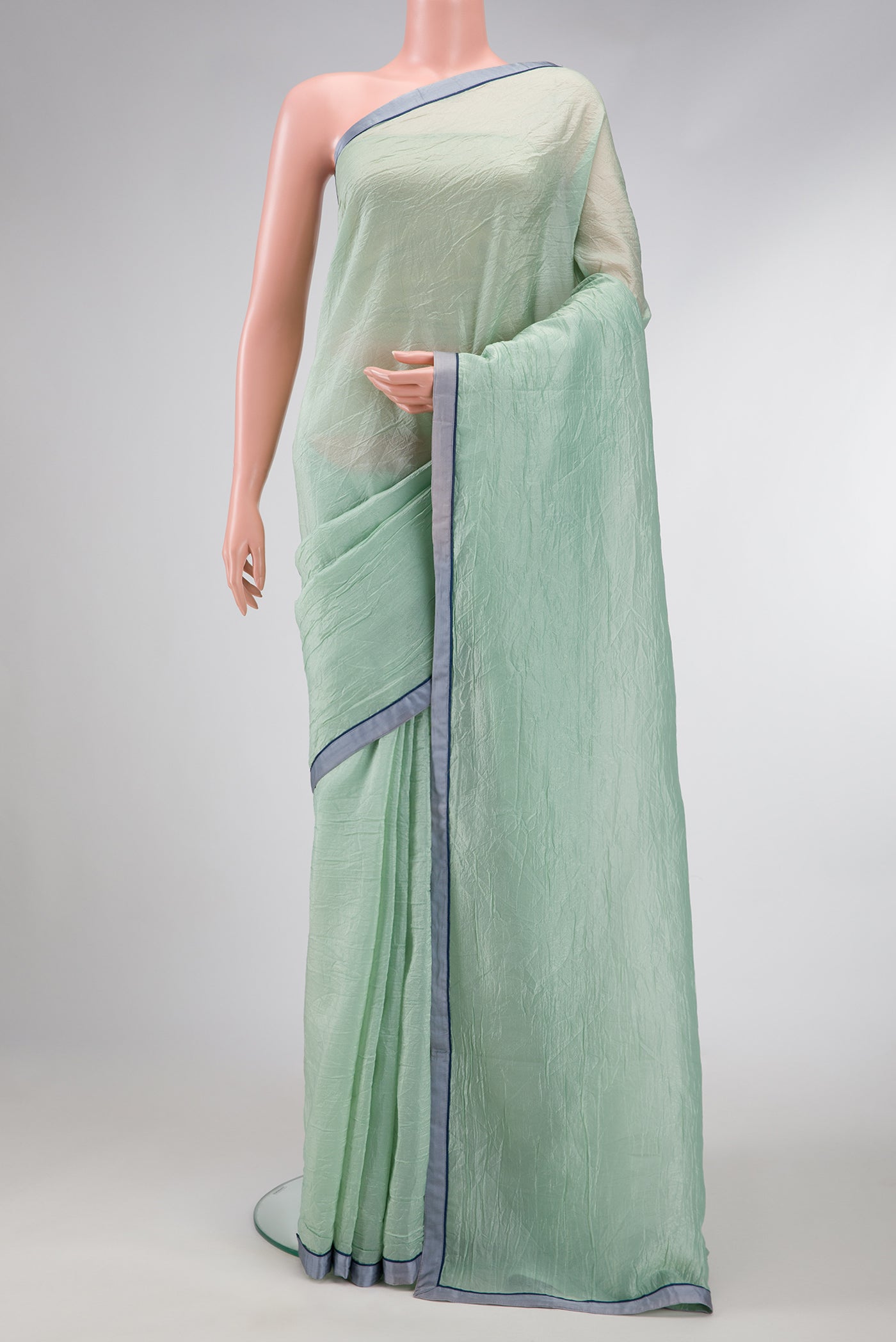 Pista Green Dual Tone Organza Silk Saree with Plain Body and Plain Border.  displayed on a mannequin