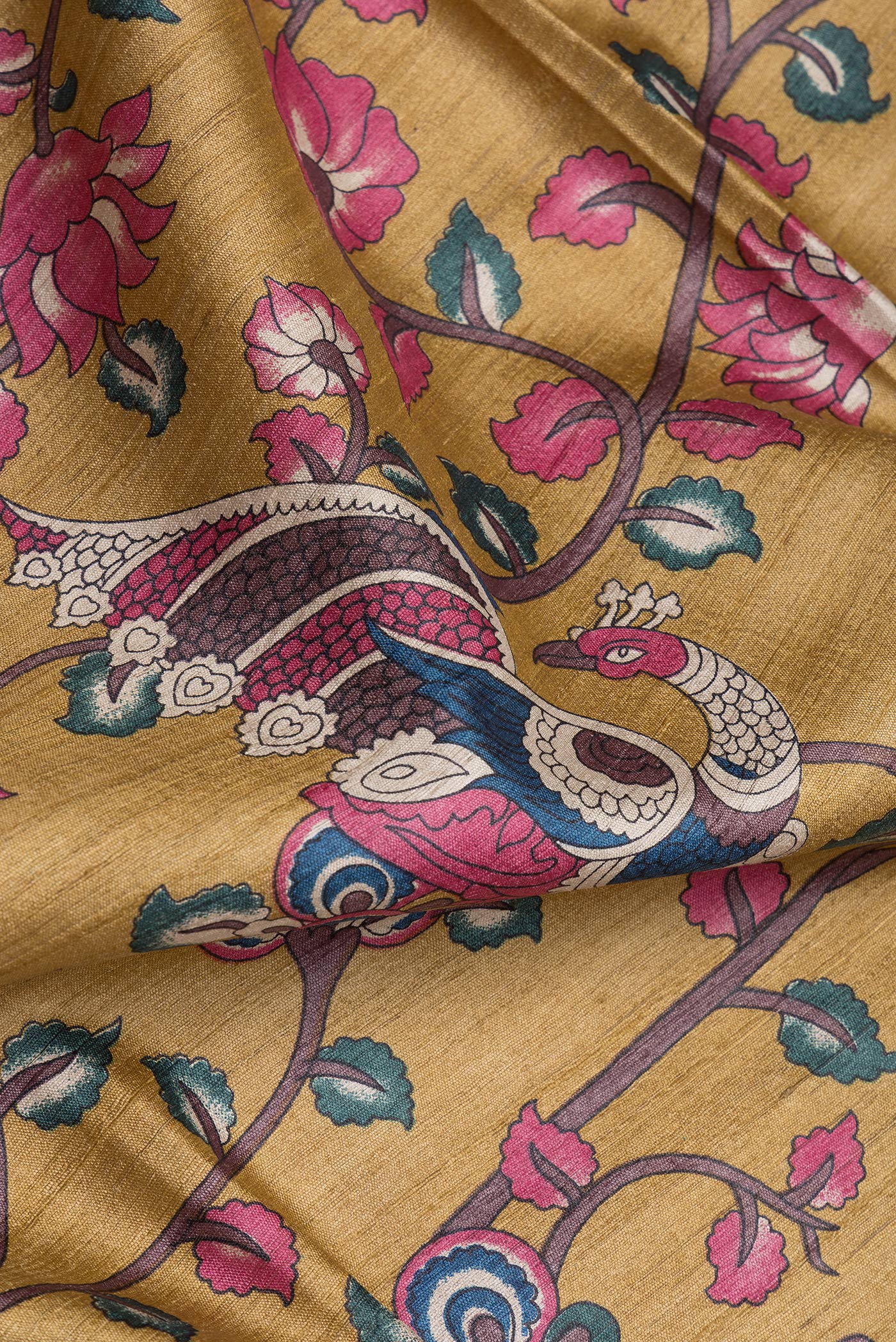 Close up of Dark Blue Tussar Silk Saree with kalamkari Print on the body and Zari Border.  displaying folds