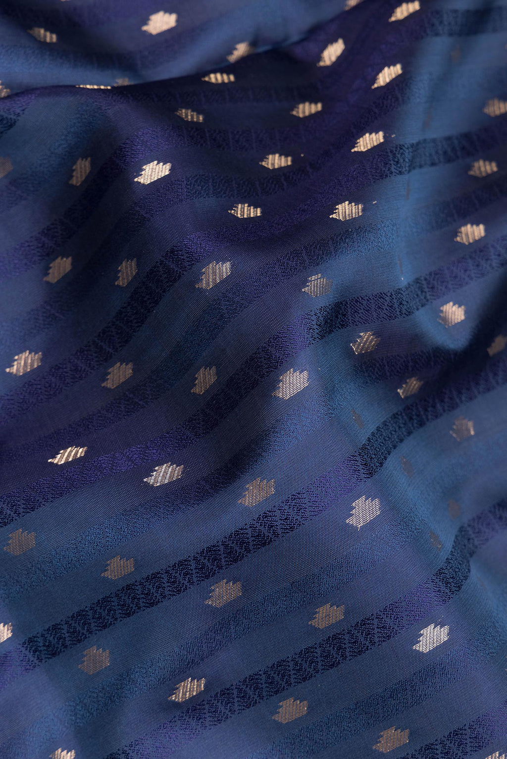 Close up of Pure Silk Navy Blue Soft Saree with Jacquard With Zari Butta on the body and Without Border.  displaying folds