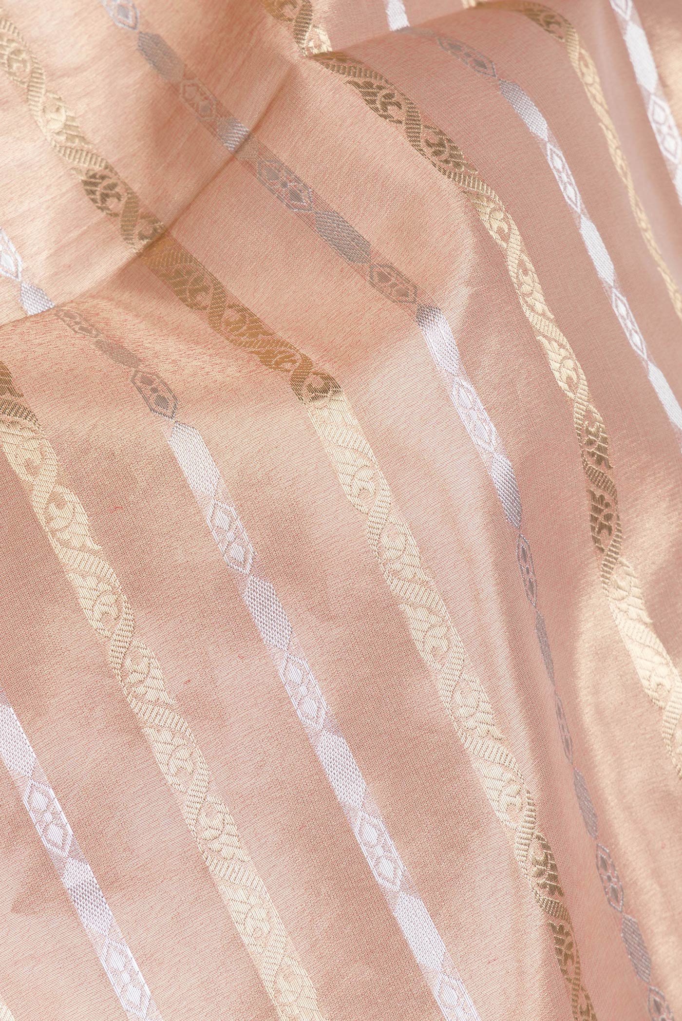 Close up of Rose Gold Dual Tone Organza Silk Saree with Stripes on the body and Fancy Border.  displaying folds