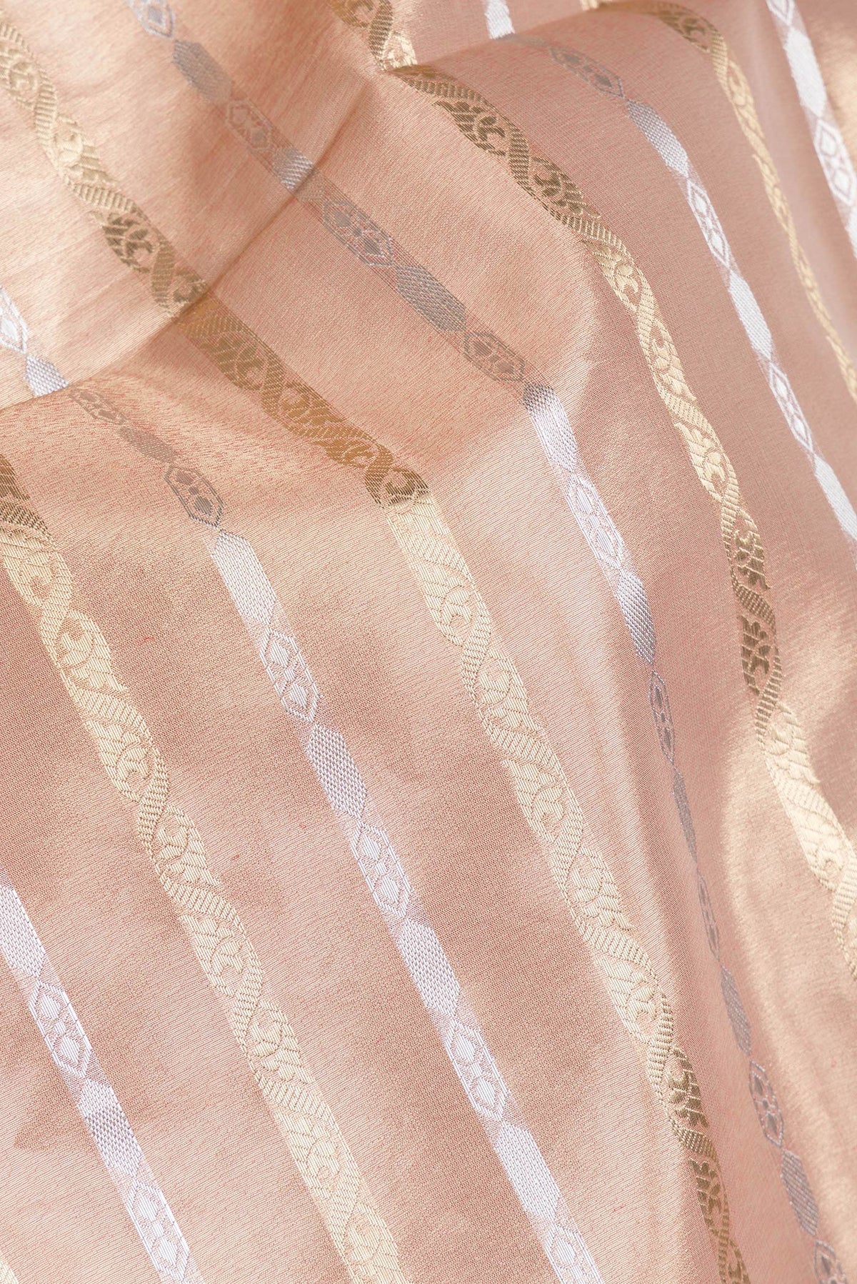 Close up of Rose Gold Dual Tone Organza Silk Saree with Stripes on the body and Fancy Border.  displaying folds