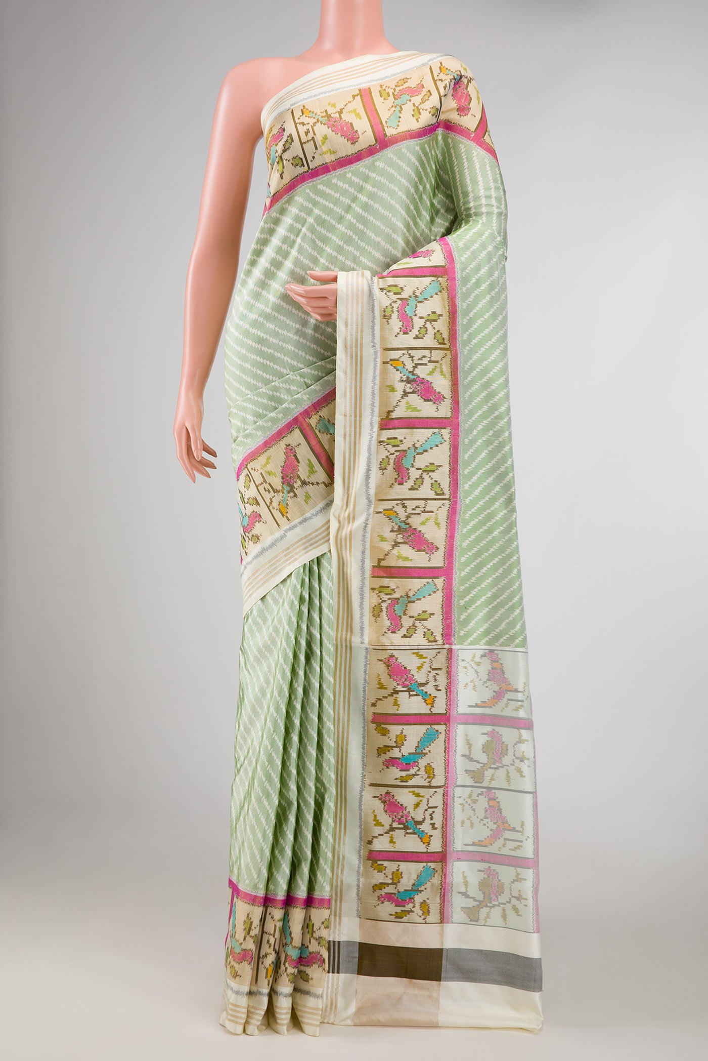 Green Dual Tone Double Ikat Saree with Ikat Print on the body and Ikat Border displayed on a mannequin