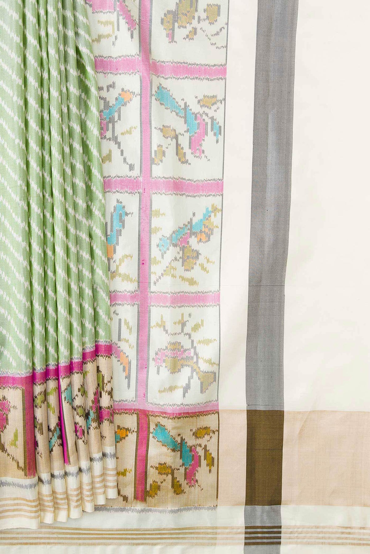 Pleats and pallu of Green Dual Tone Double Ikat Saree with Ikat Print on the body and Ikat Border