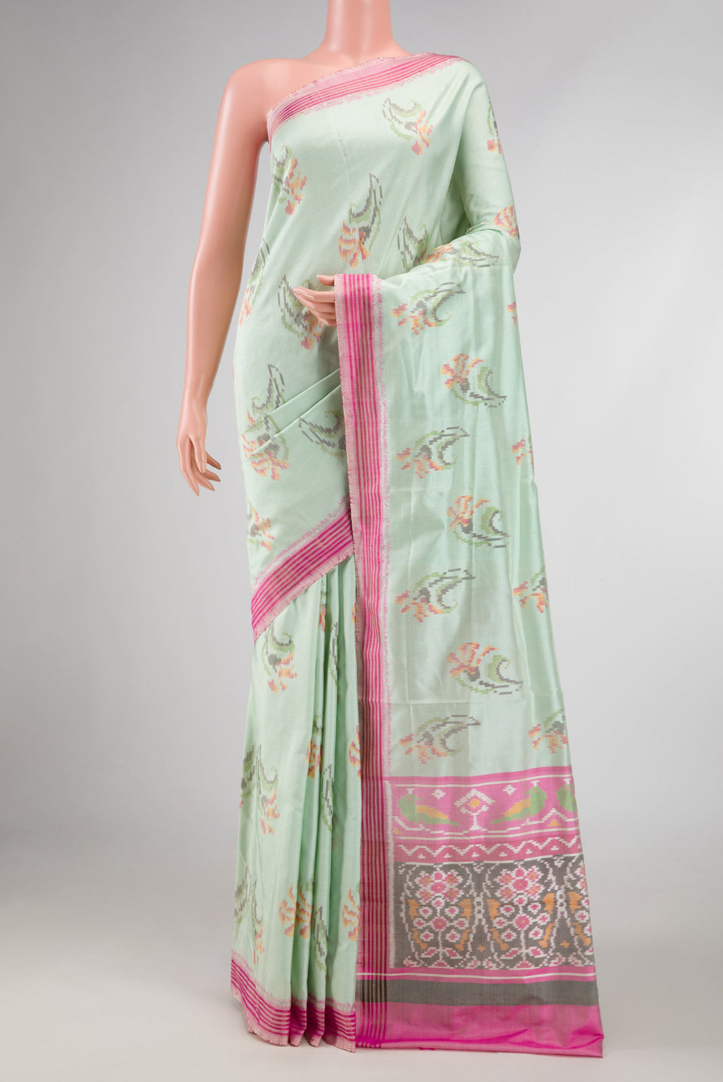 Light Green Dual Tone Double Ikat Saree with Ikat Print on the body and Zari And Thread Border displayed on a mannequin