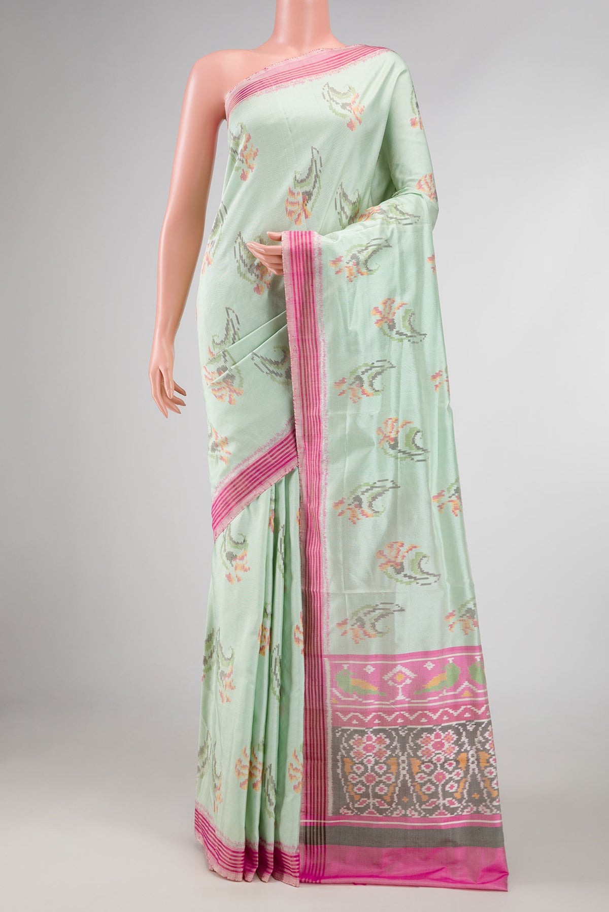 Light Green Dual Tone Double Ikat Saree with Ikat Print on the body and Zari And Thread Border displayed on a mannequin