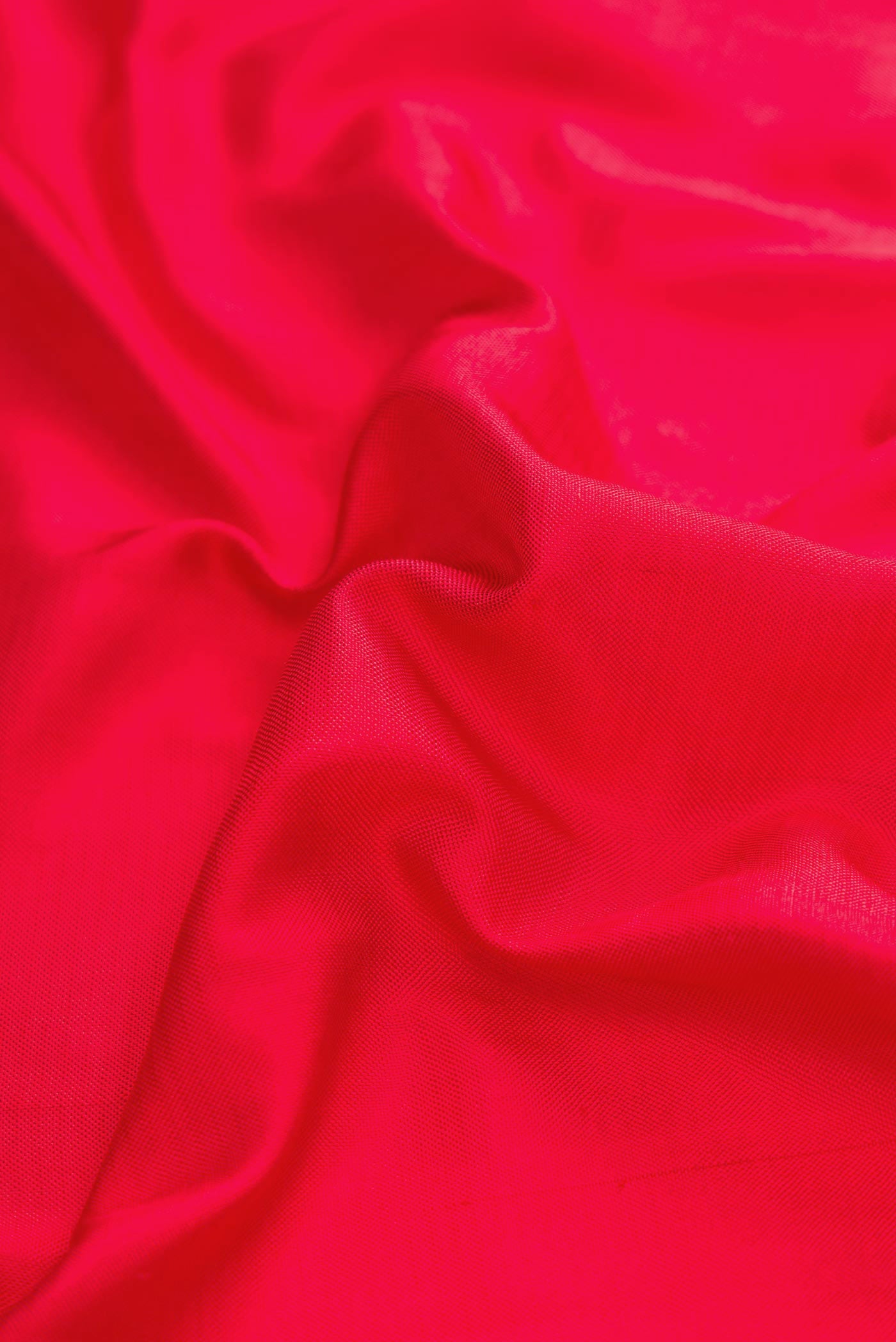 Close up of Red Dual Tone Double Ikat Saree with Plain Body and Ikat Border displaying folds
