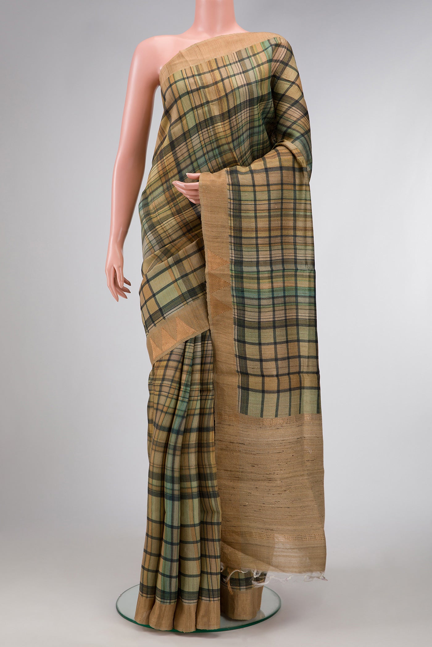 Mehandi Green Dual Tone Tussar Saree with Printed design on the body and Zari Border.  displayed on a mannequin