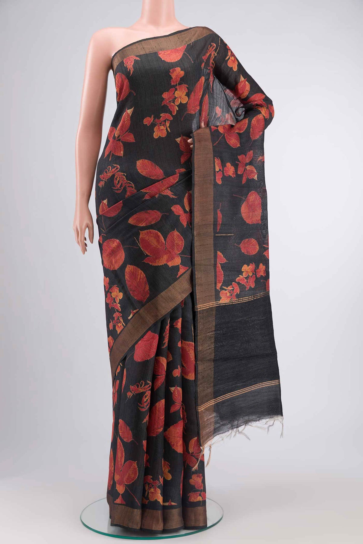 Black Tussar Silk SareePrinted design on the body and Zari Border displayed on a mannequin