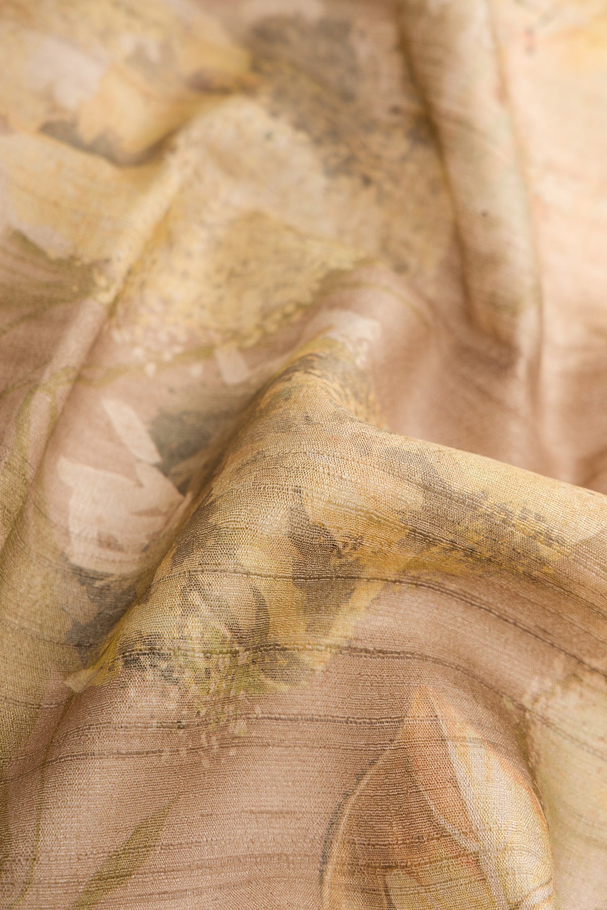 Close up of Dark Beige Dual Tone Tussar Silk Saree with Printed design on the body and Zari Border.  displaying folds