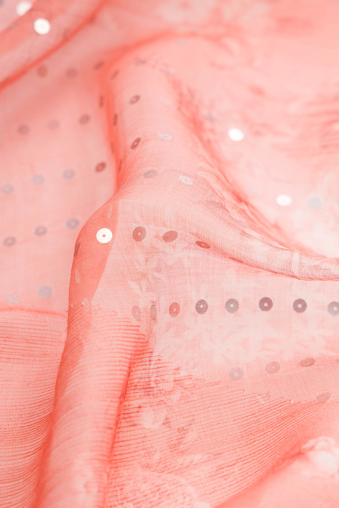 Close up of Peach Dual Tone Tussar Silk Saree with Embroidery on the body and Embroidery Border displaying folds