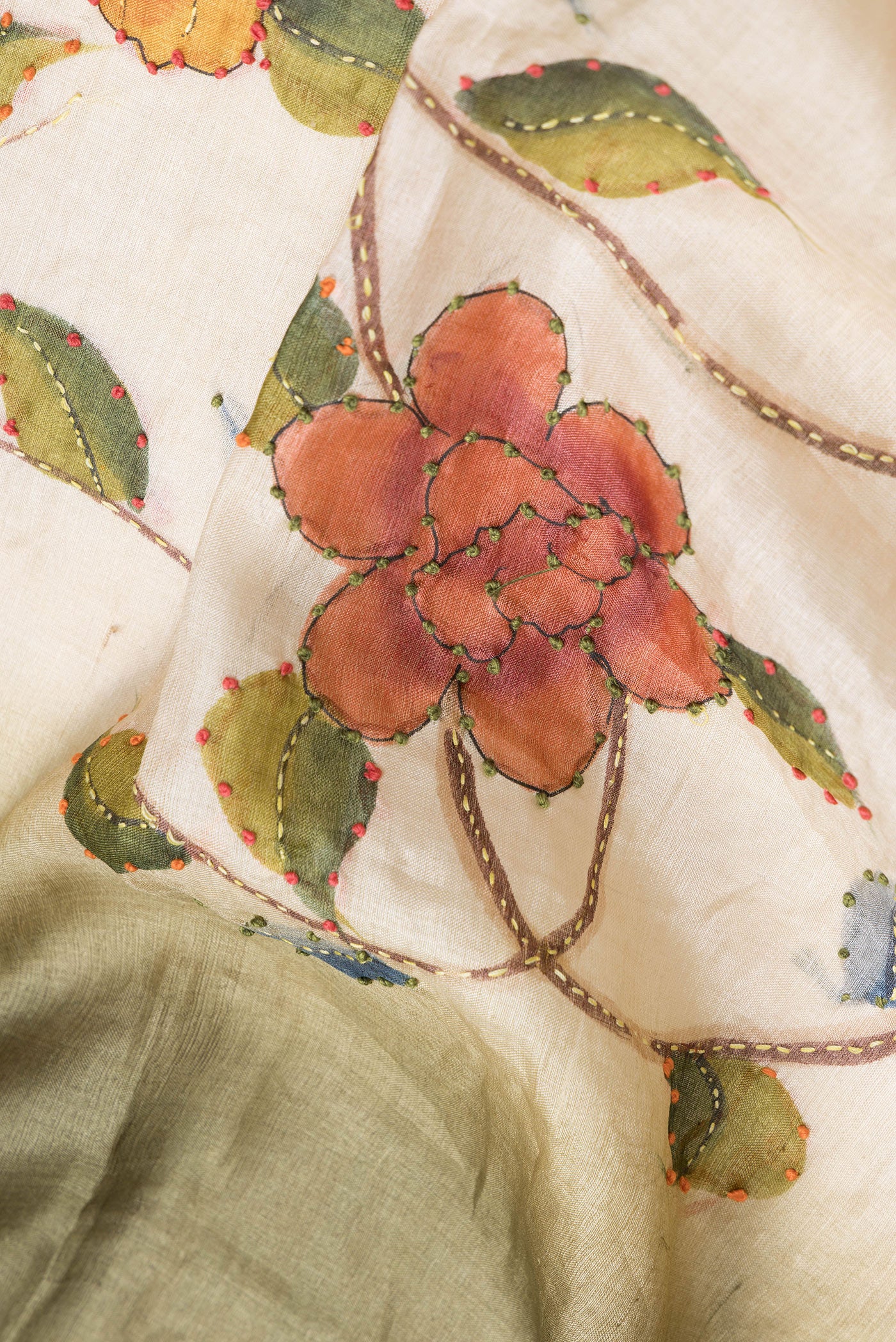 Close up of Beige Dual Tone Tussar Silk Saree with Embroidery on the body and Zari Border.  displaying folds