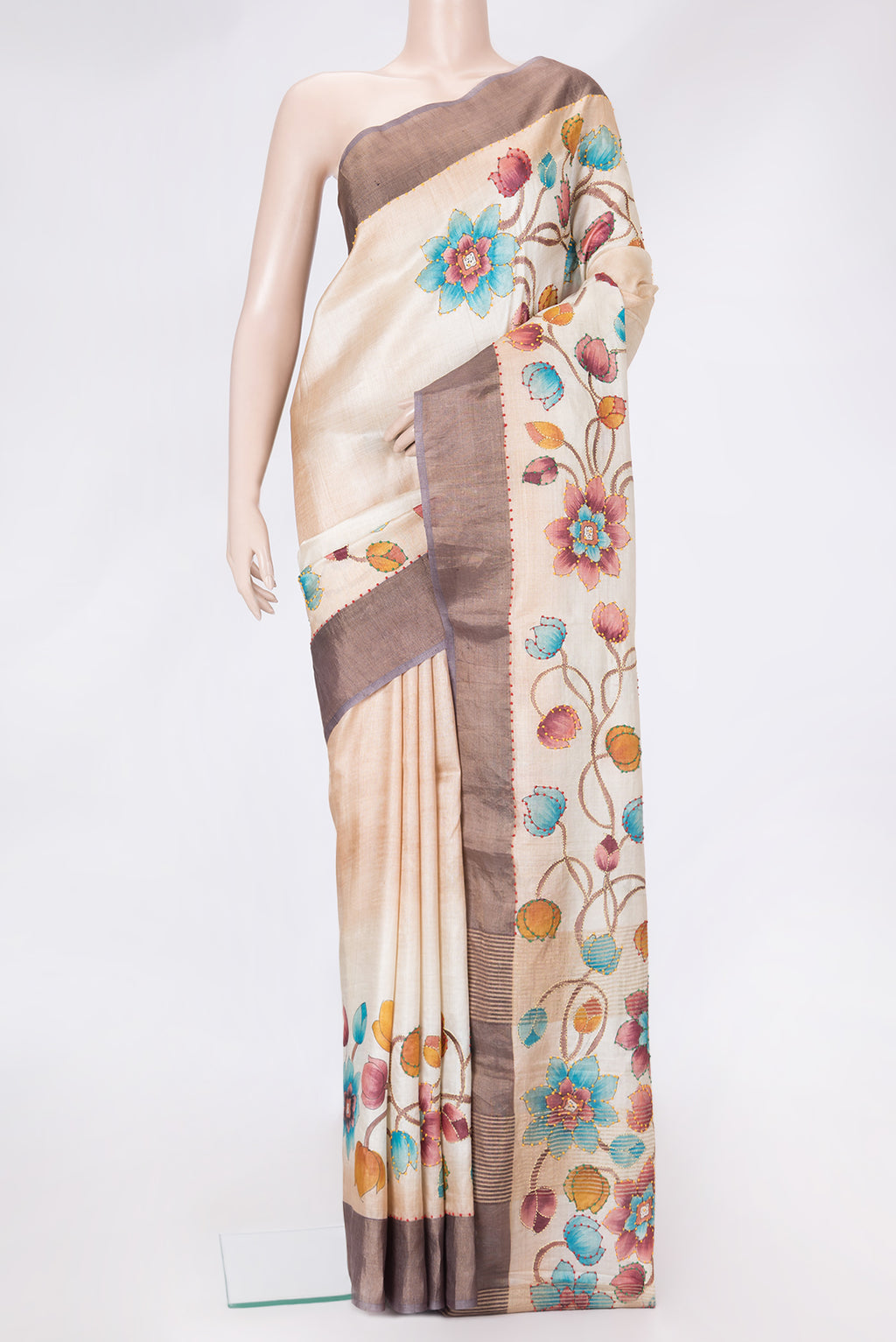 Beige Dual Tone Tussar Silk Saree with Embroidery on the body and Zari Border.  displayed on a mannequin