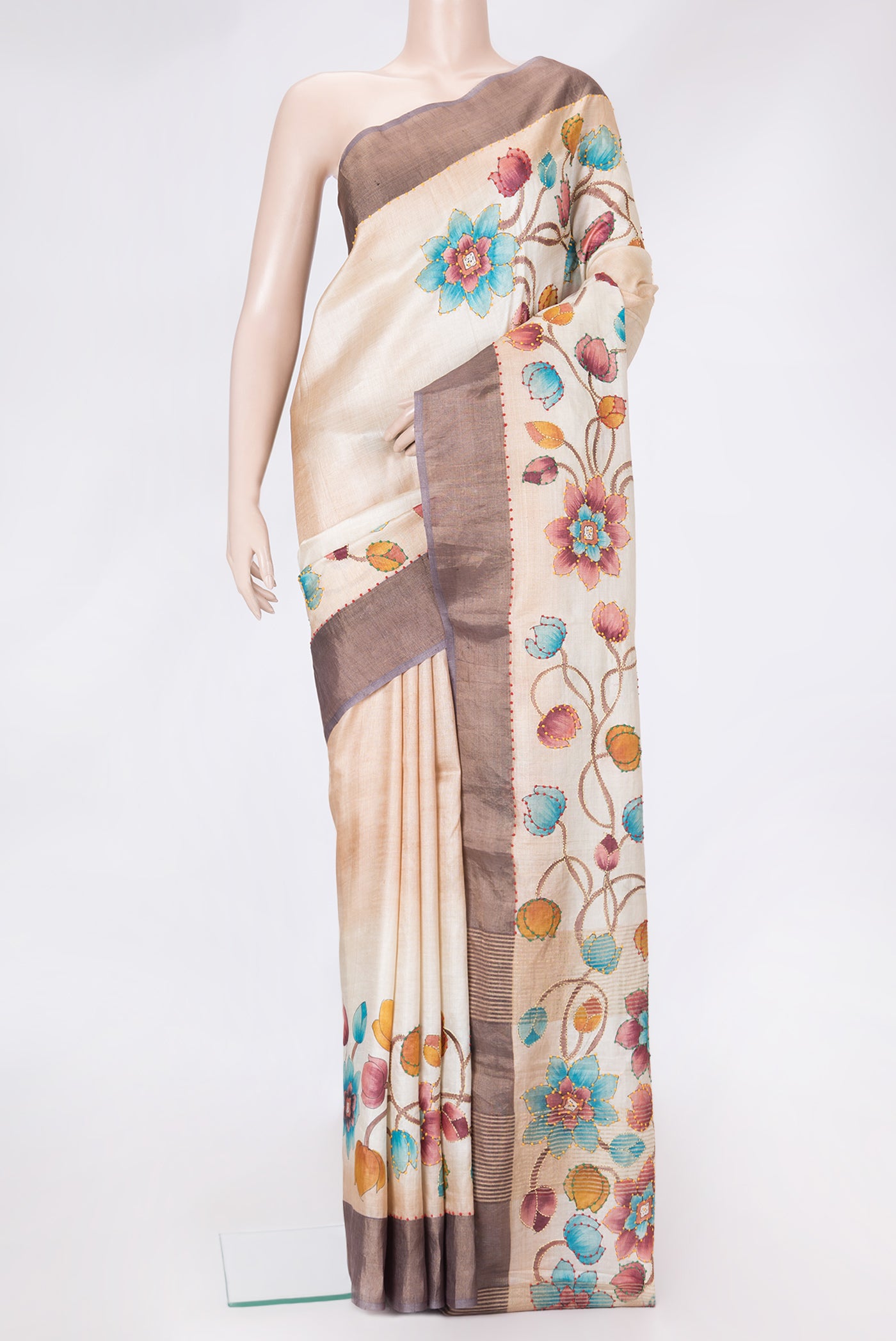 Beige Dual Tone Tussar Silk Saree with Embroidery on the body and Zari Border.  displayed on a mannequin