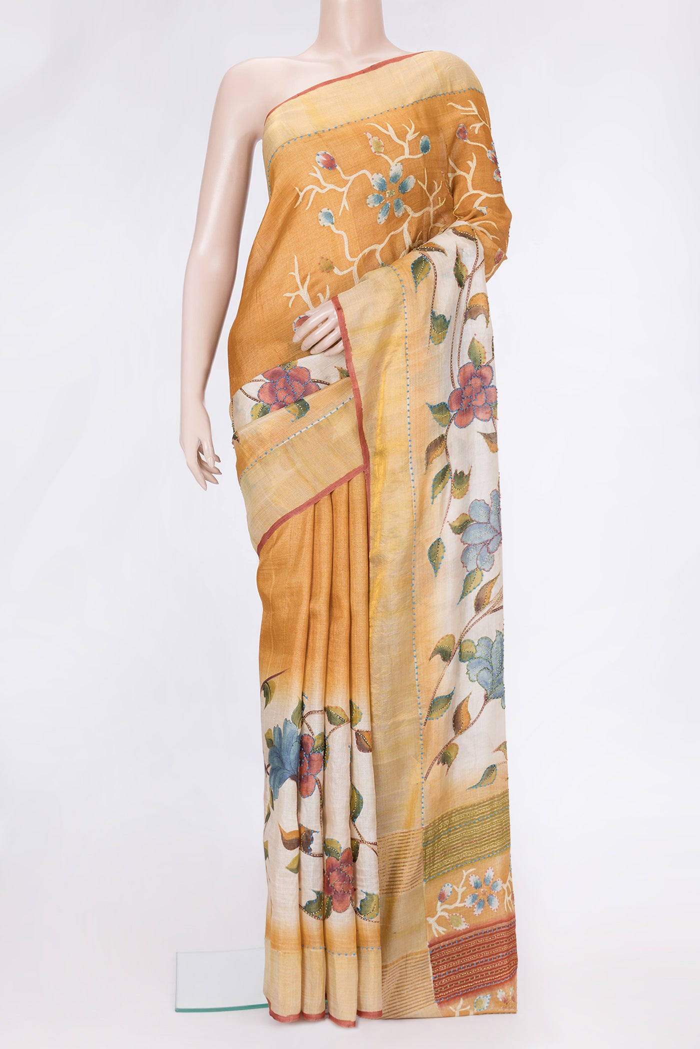 Mustard Dual Tone Tussar Silk Saree with Embroidery on the body and Zari Border.  displayed on a mannequin