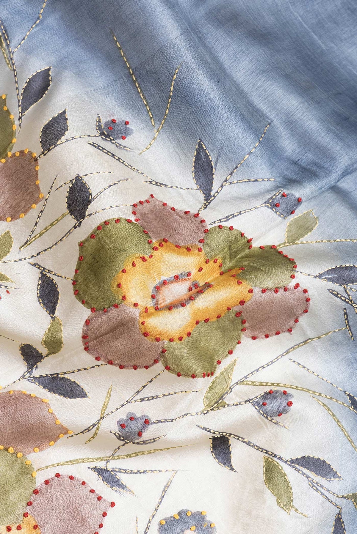 Close up of Grey Dual Tone Tussar Silk Saree with Embroidery on the body and Zari Border.  displaying folds