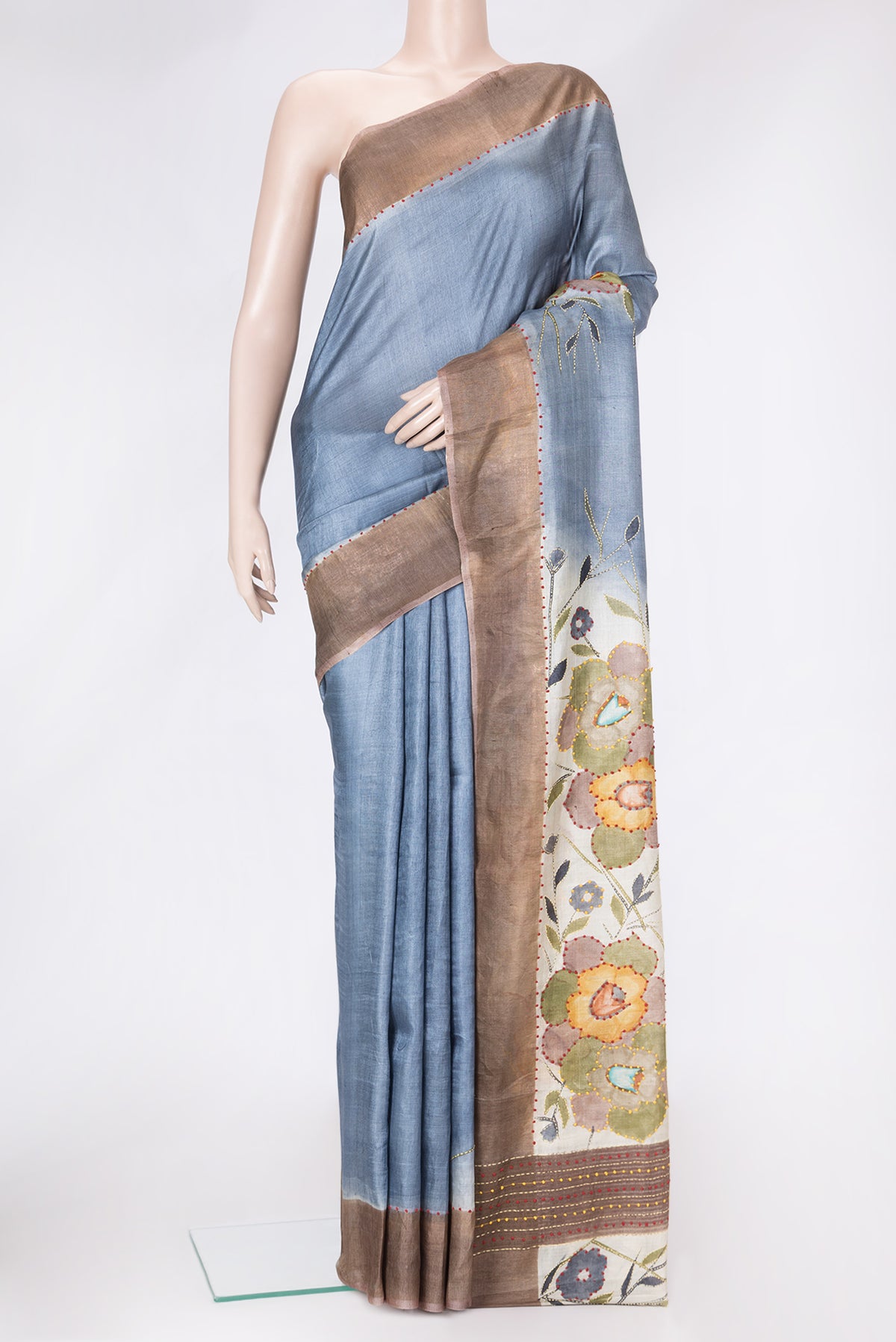 Grey Dual Tone Tussar Silk Saree with Embroidery on the body and Zari Border.  displayed on a mannequin