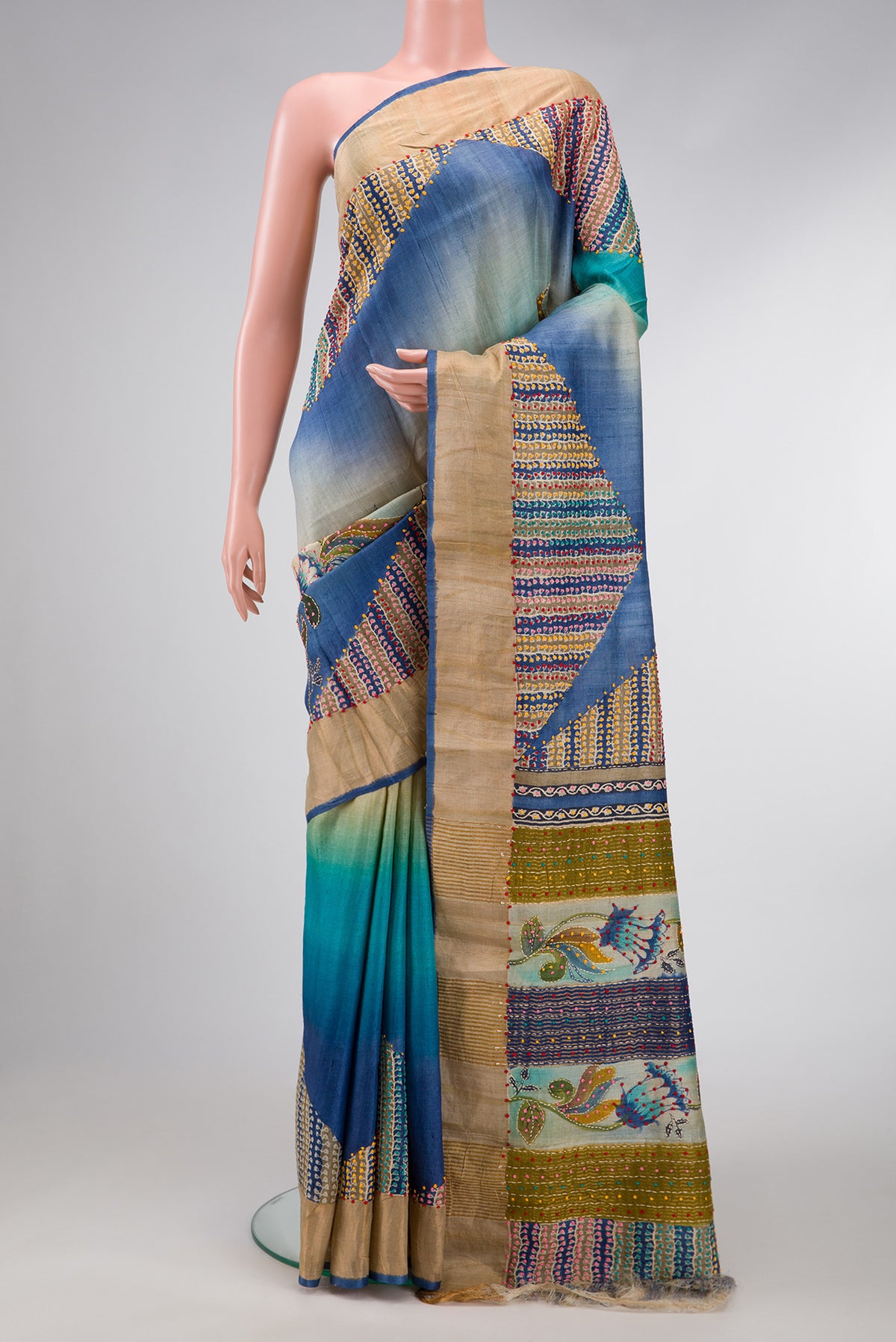 Blue and Beige Color Tussar Saree with Printed design on the body and Embroidery Border.  displayed on a mannequin