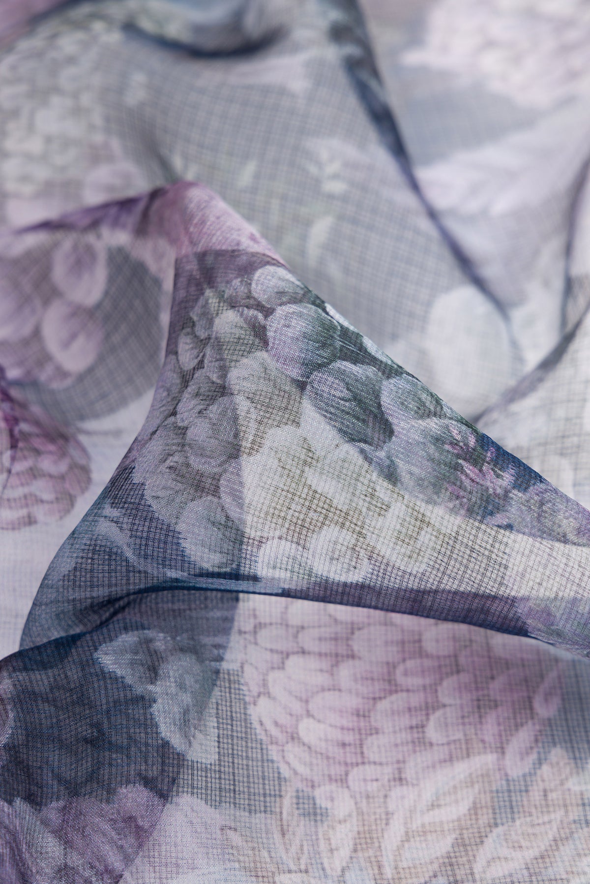 Close up of Navy Blue Dual Tone Tussar Silk Saree with Printed design on the body and Zari Border.  displaying folds