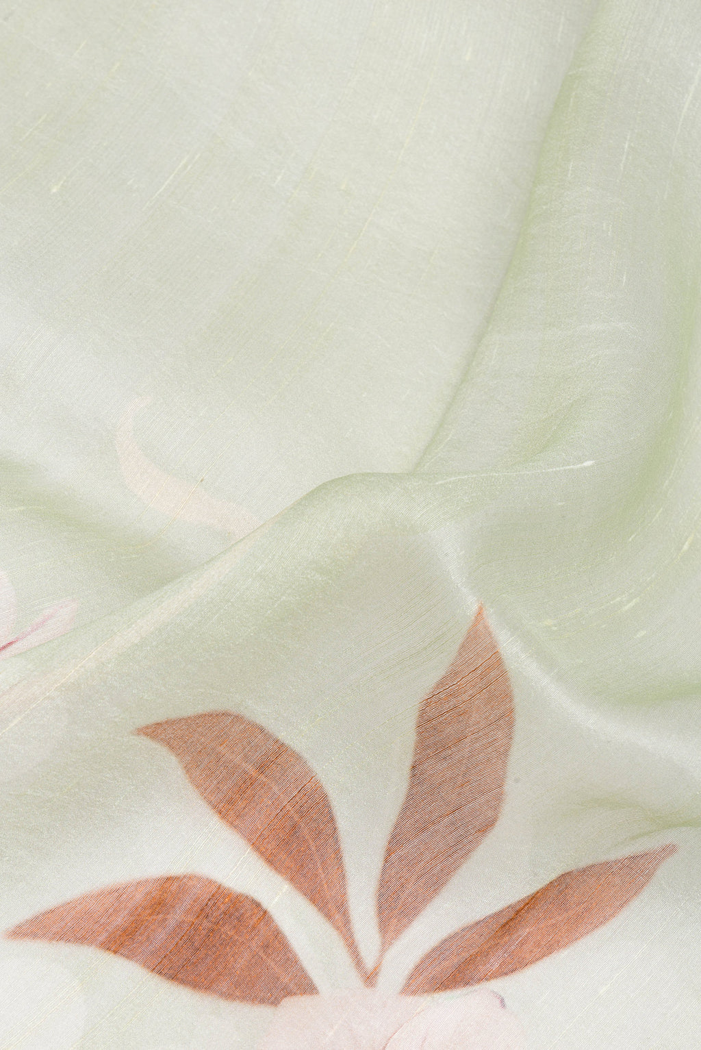 Close up of Pista Green Linen Saree with Printed design on the body and Plain Border.  displaying folds