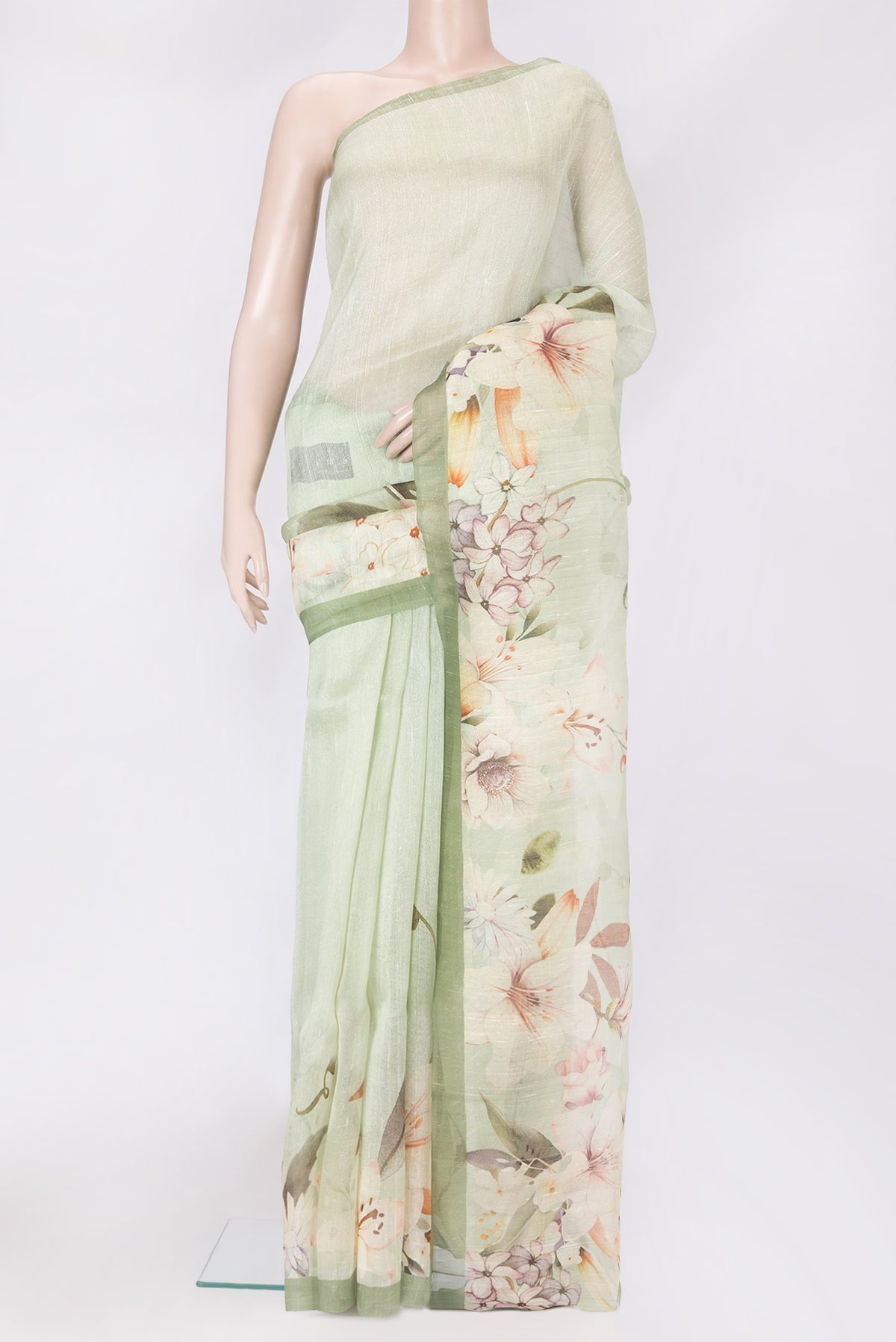 Pista Green Linen Saree with Printed design on the body and Plain Border.  displayed on a mannequin